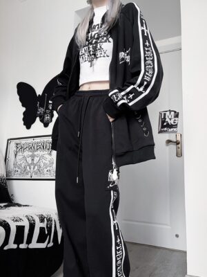 Oversized black Jirai Kei gothic jacket and wide-leg pants set with side letter prints worn on female model - full-body side view in dark interior