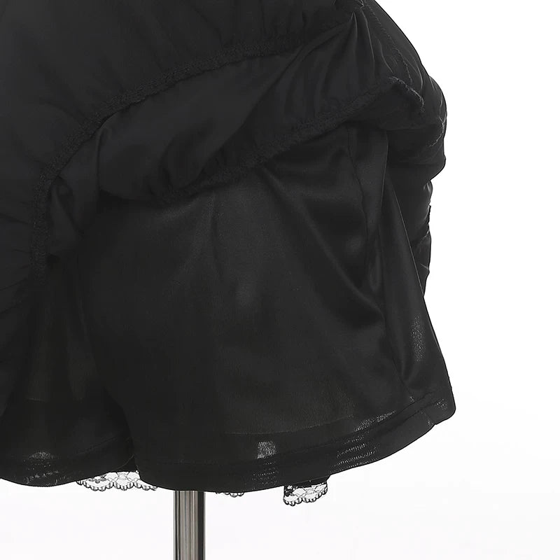 Side view close-up of layered black lace Jirai Kei skirt hem with ruffled silhouette and lace trim detail