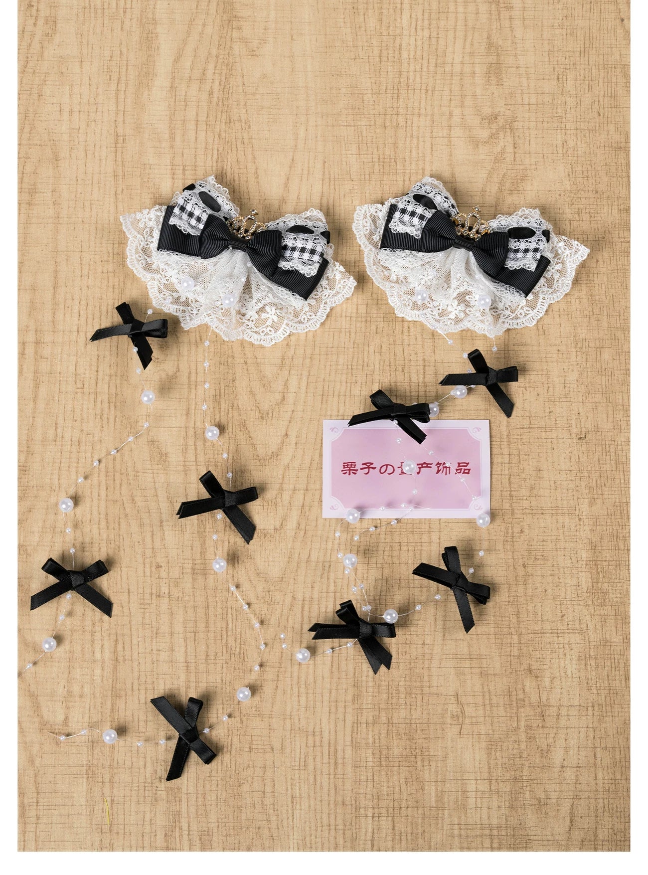 Overhead view of Gothic checkered Jirai Kei hair clip featuring black-white plaid bow, lace trim, and black cross pearl chains