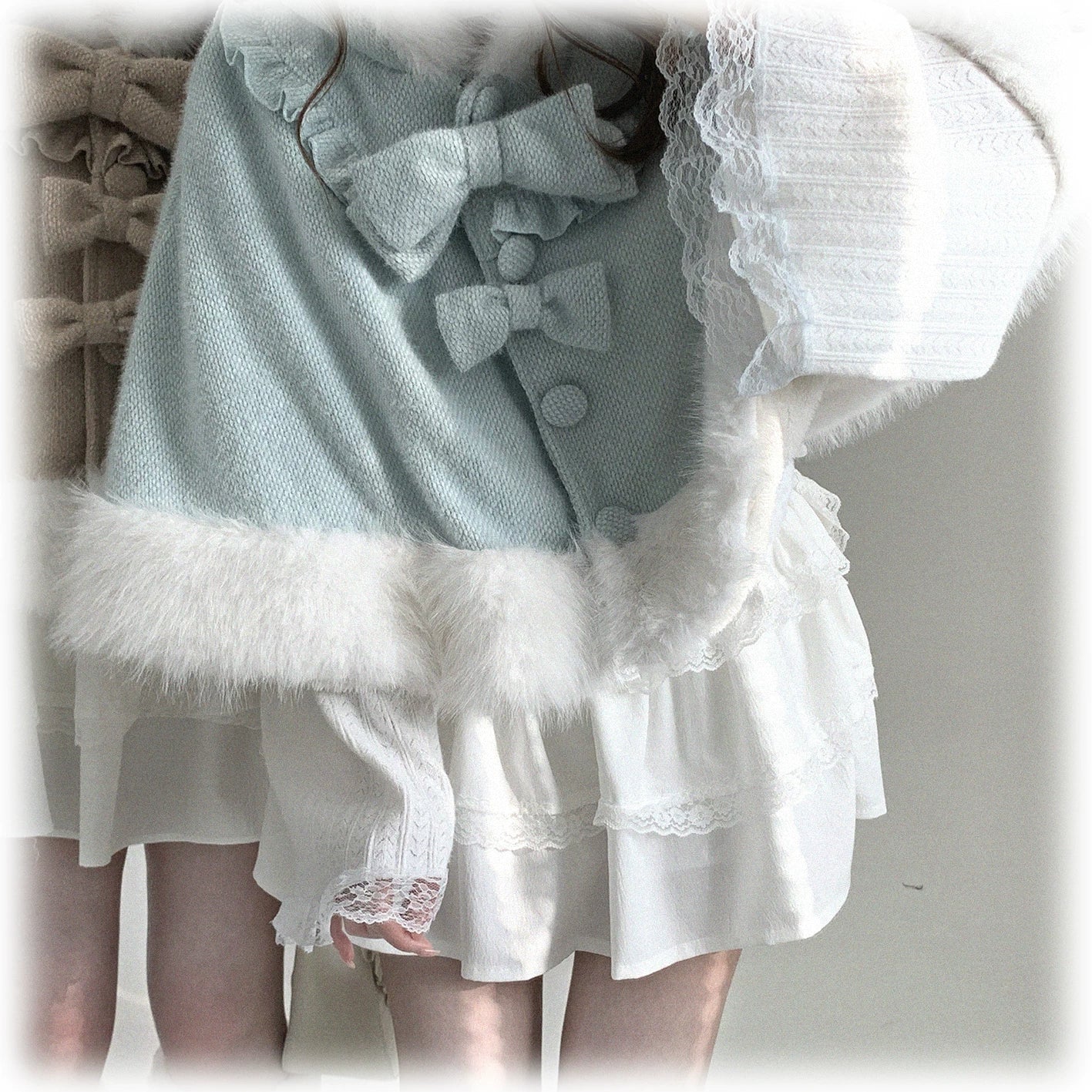 Mint green cat-ear hooded cape modeled in full-body shot, featuring white fuzzy trim and detachable bow for soft Jirai Kei aesthetic