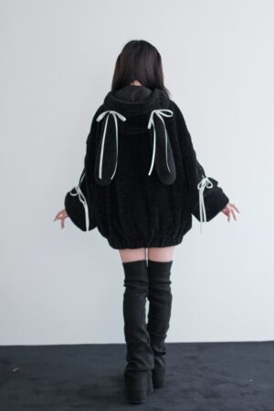 Black fuzzy bunny ear jirai kei coat back view showing decorative bunny ear hanging details with white ribbons and drawstring cuff design