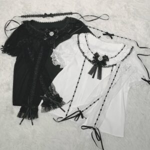 Flat lay styling shot of complete Jirai Kei blouse set including black and white tones with lace trims, detachable chest bow, ribbon choker, and long sheer tulle cuff accessories