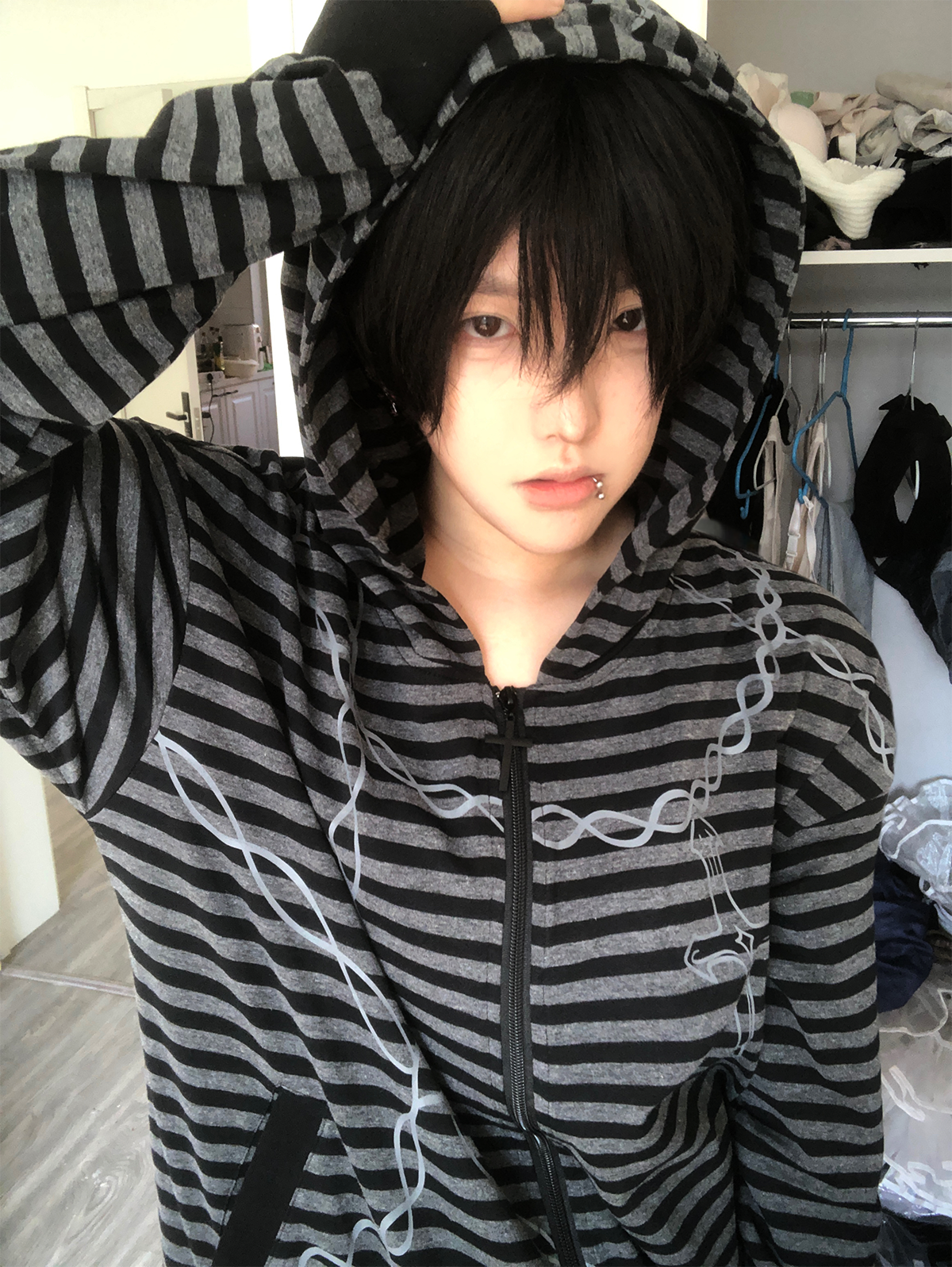 Gothic striped zip-up hoodie side profile view emphasizing oversized fit proportions and ruffled hem design elements