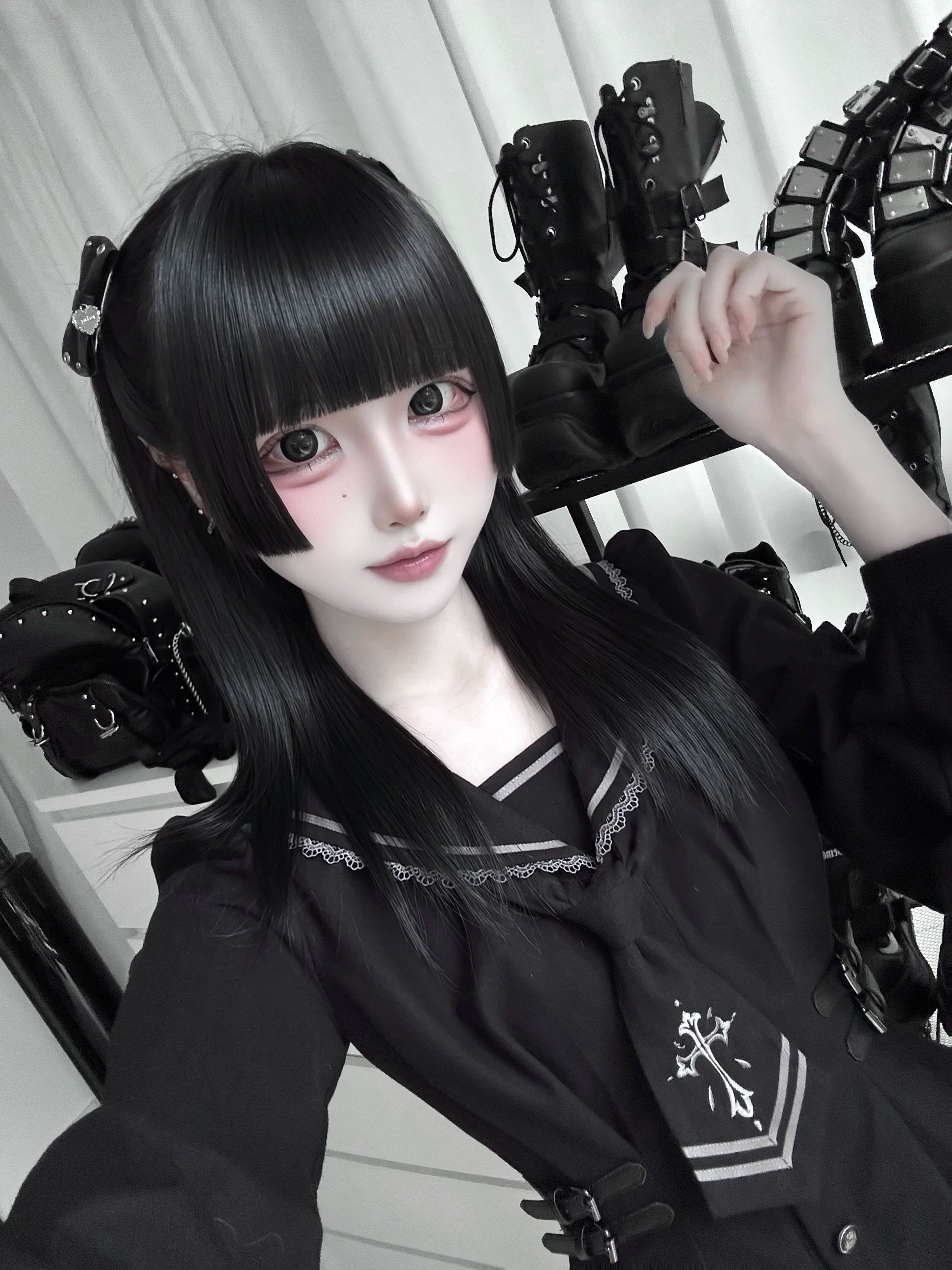 Close-up selfie view of black sailor JK uniform blouse featuring cross chest embroidery, adjustable waist straps, and sailor collar detail