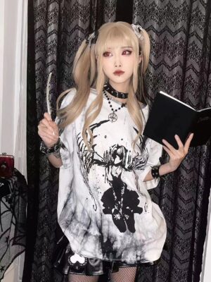 Blonde model wearing celestial angel wings tie-dye gothic jirai kei unisex oversized t-shirt, front full-body view with dark curtain background