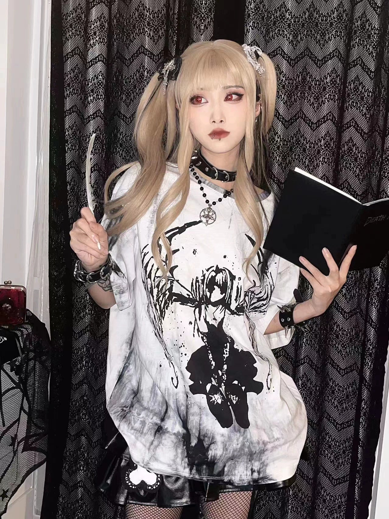 Blonde model wearing celestial angel wings tie-dye gothic jirai kei unisex oversized t-shirt, front full-body view with dark curtain background