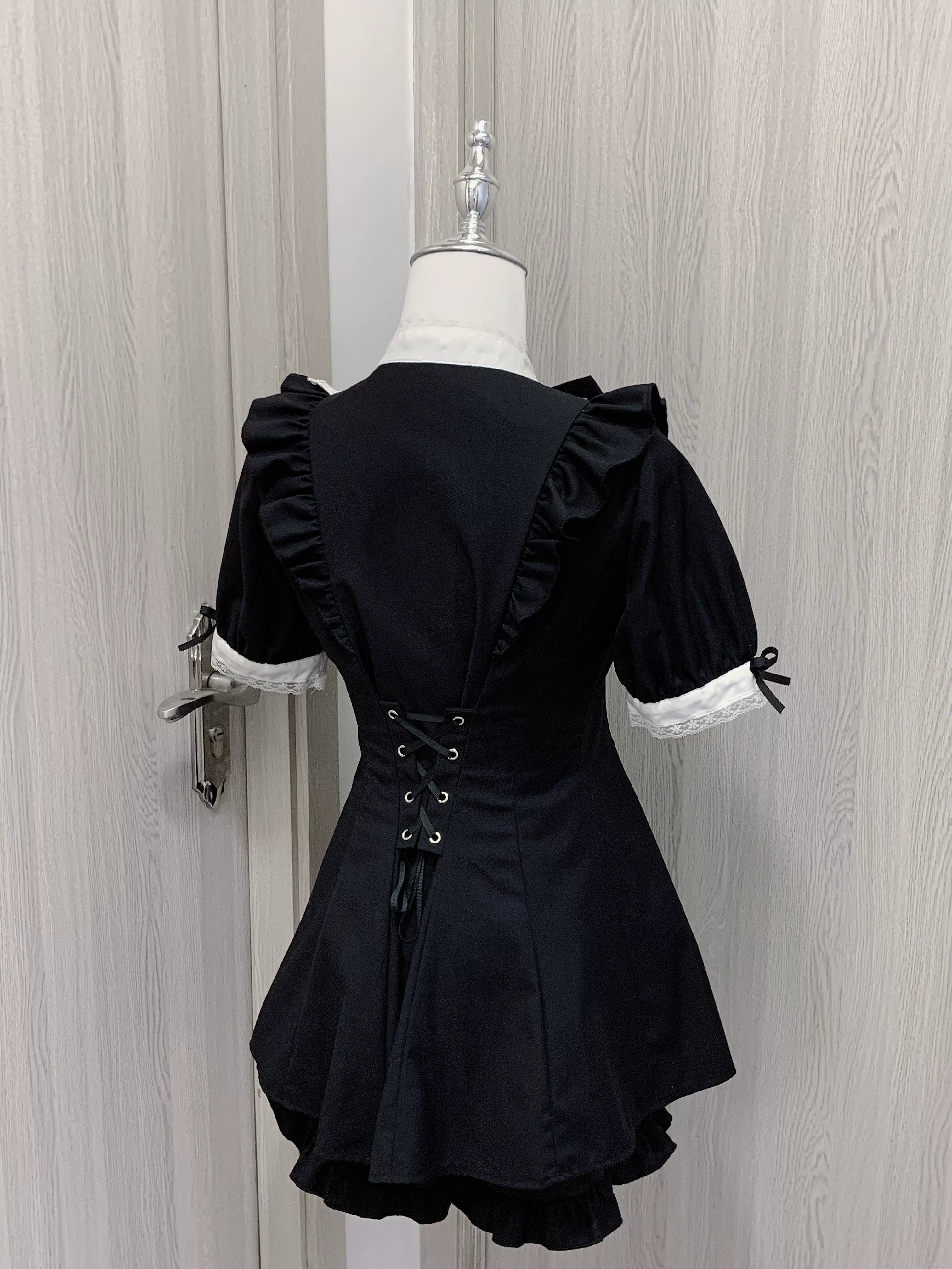 Back view of Jirai Kei dress with corset-style lace-up closure, ruffled shoulder and hem details, layered undershorts design