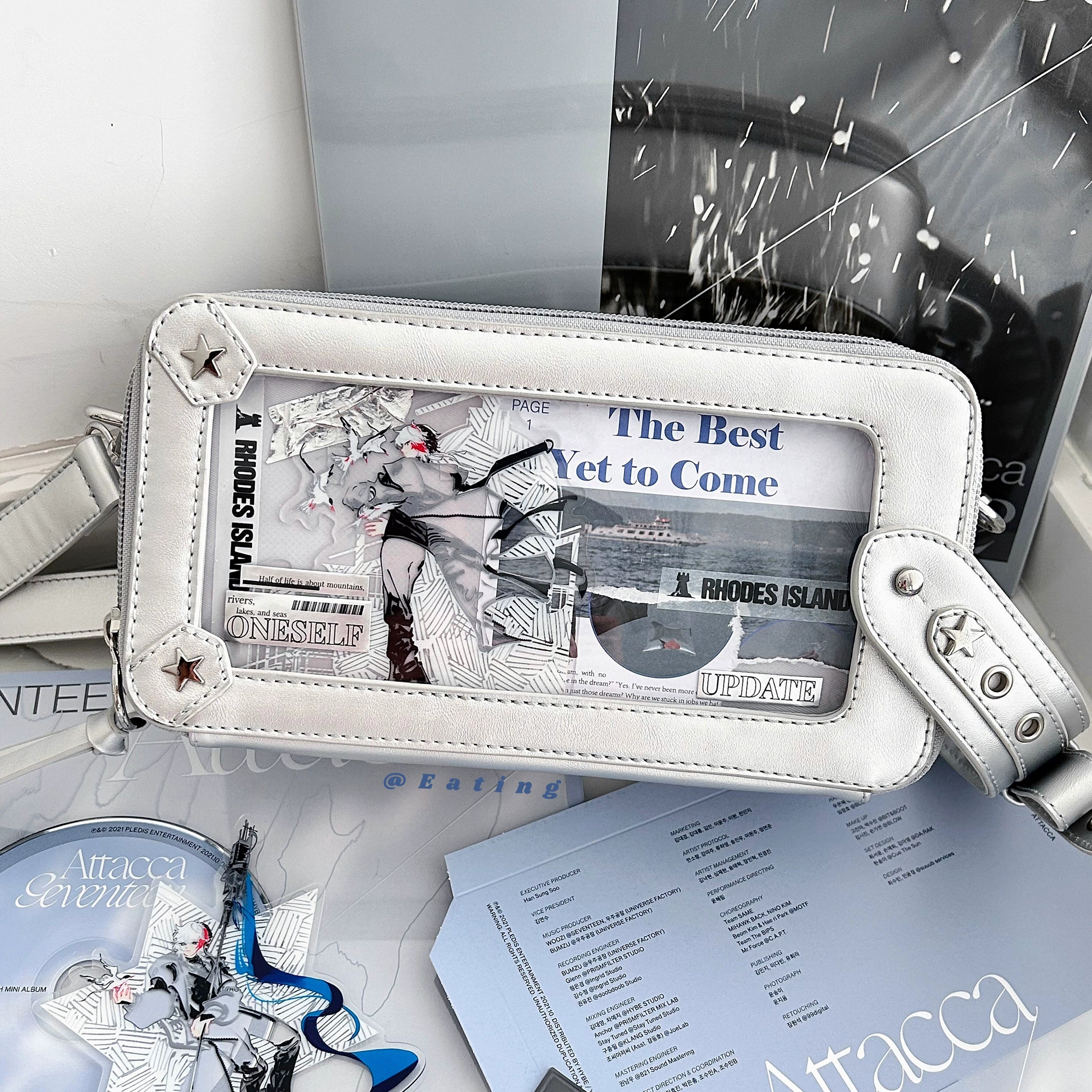 White jirai kei brick itabag crossbody bag overhead flat lay with transparent display window and star metal hardware anime peripheral background