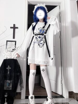 White gothic printed long sleeve Jirai Kei tee with blue skull cross print and detachable leather straps, full-body front view on blue-haired alternative model with lace hem