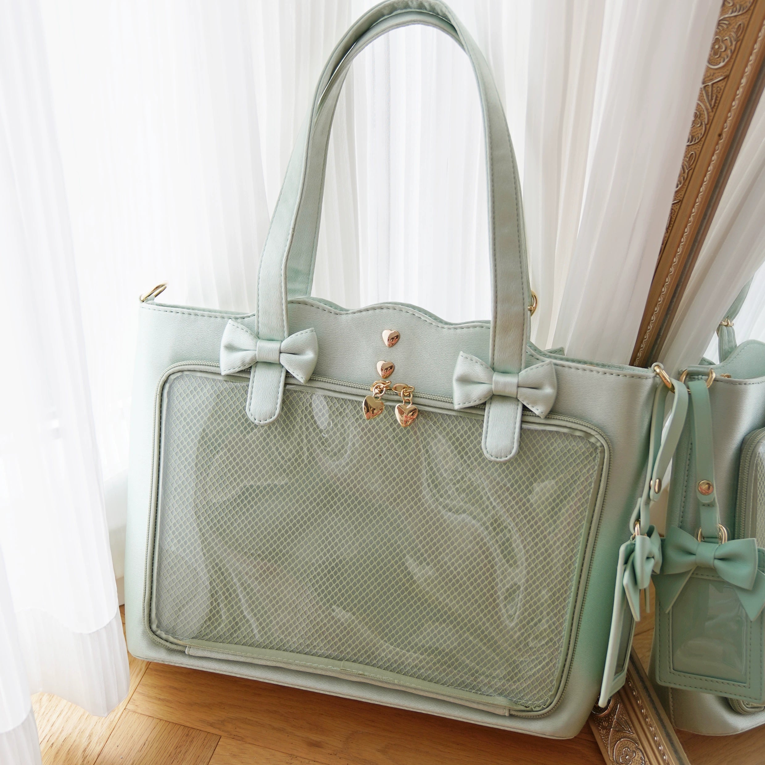 Green Jirai Kei ita bag color option featuring heart-shaped metal adjustable buckle, transparent badge display window, wavy edge tote design, bow accents, and large capacity collection showcase