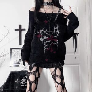 Black off-shoulder gothic fuzzy sweater with cross-thorn blood print and leather buckle straps, front half-body view on dark background