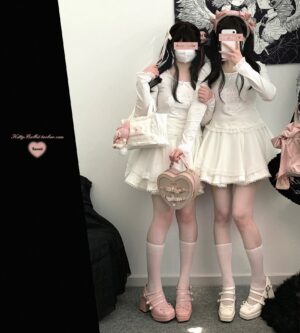 White double-layer ruffled tulle Jirai Kei mini skirt with rhinestone waistband embellishments worn in full-body mirror selfie by two girls in sweet Lolita outfits with heart-shaped handbags and platform shoes