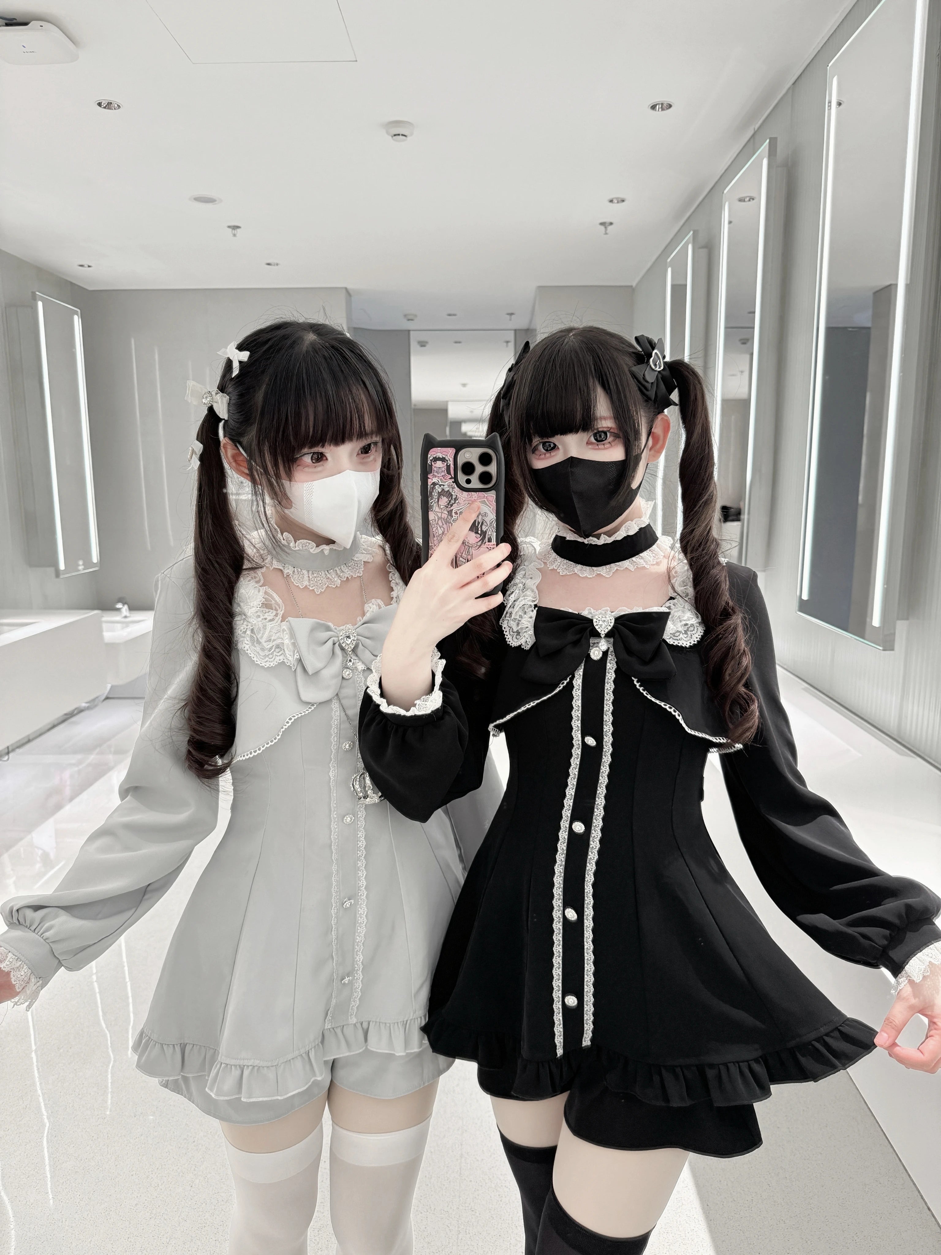 Jirai Kei long-sleeve dress with pocketed shorts in black and gray, front mirror view with ruffled lace and rhinestone details on female models