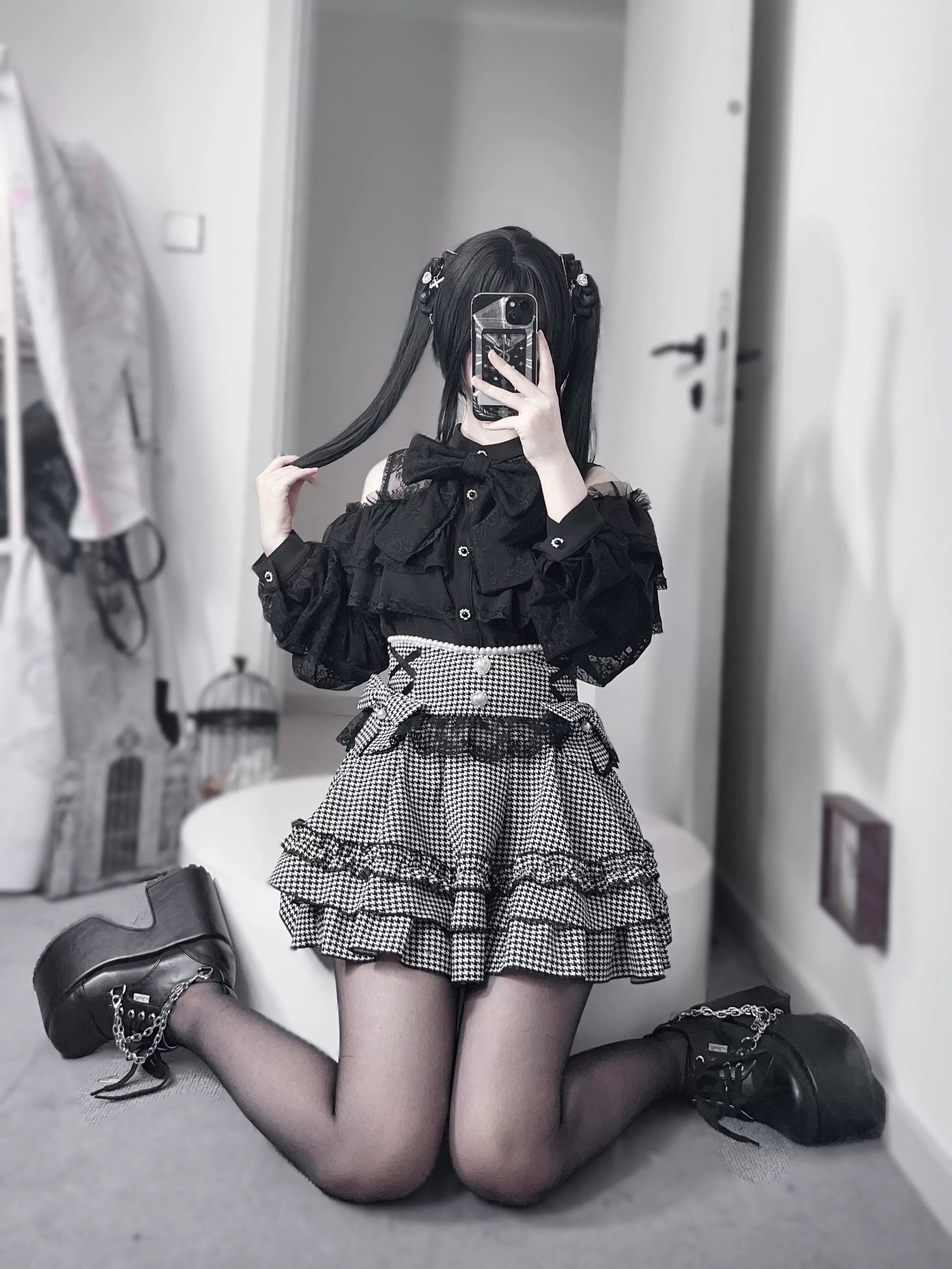 Black jirai kei detachable bow ruffle mini skirt product detail showing fabric texture and construction quality, flat lay display