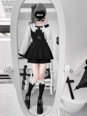 Model wearing solid black Jirai Kei dress set with cropped ruffled shorts, platform boots and ruffled socks in full-length mirror selfie gothic interior