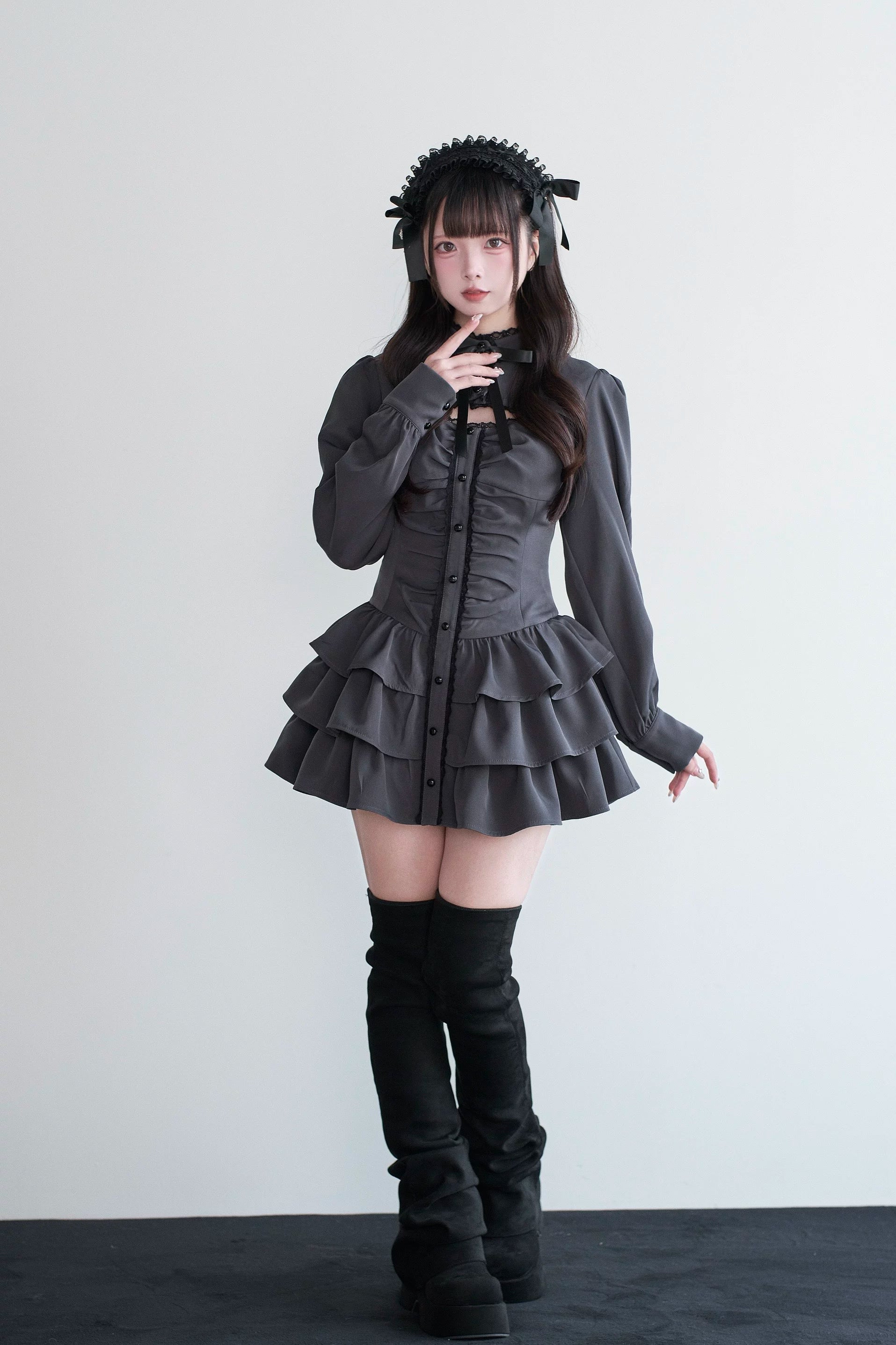Black Jirai Kei gothic dress front standing view with tiered mini skirt and long puff sleeves