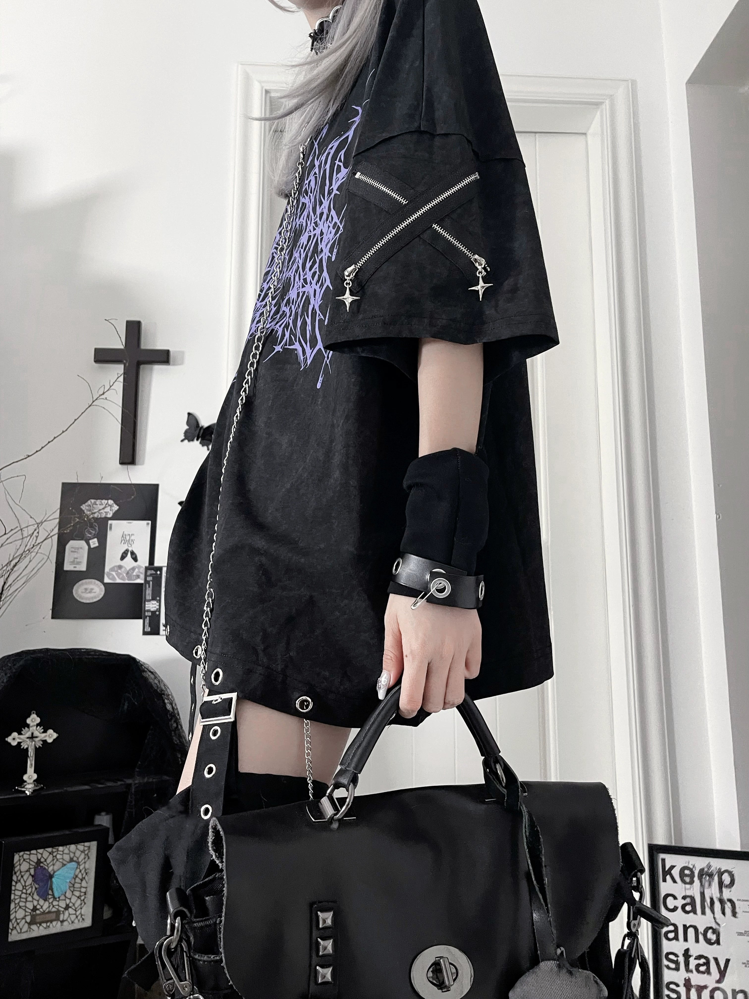 Side partial view of Jirai Kei purple thorn print t-shirt styled with matching leather handbag and sleeve zipper details