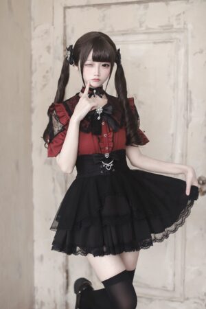 Red and black Jirai Kei ruffle sleeve blouse with lace trim and metal waist charm three-quarter view model