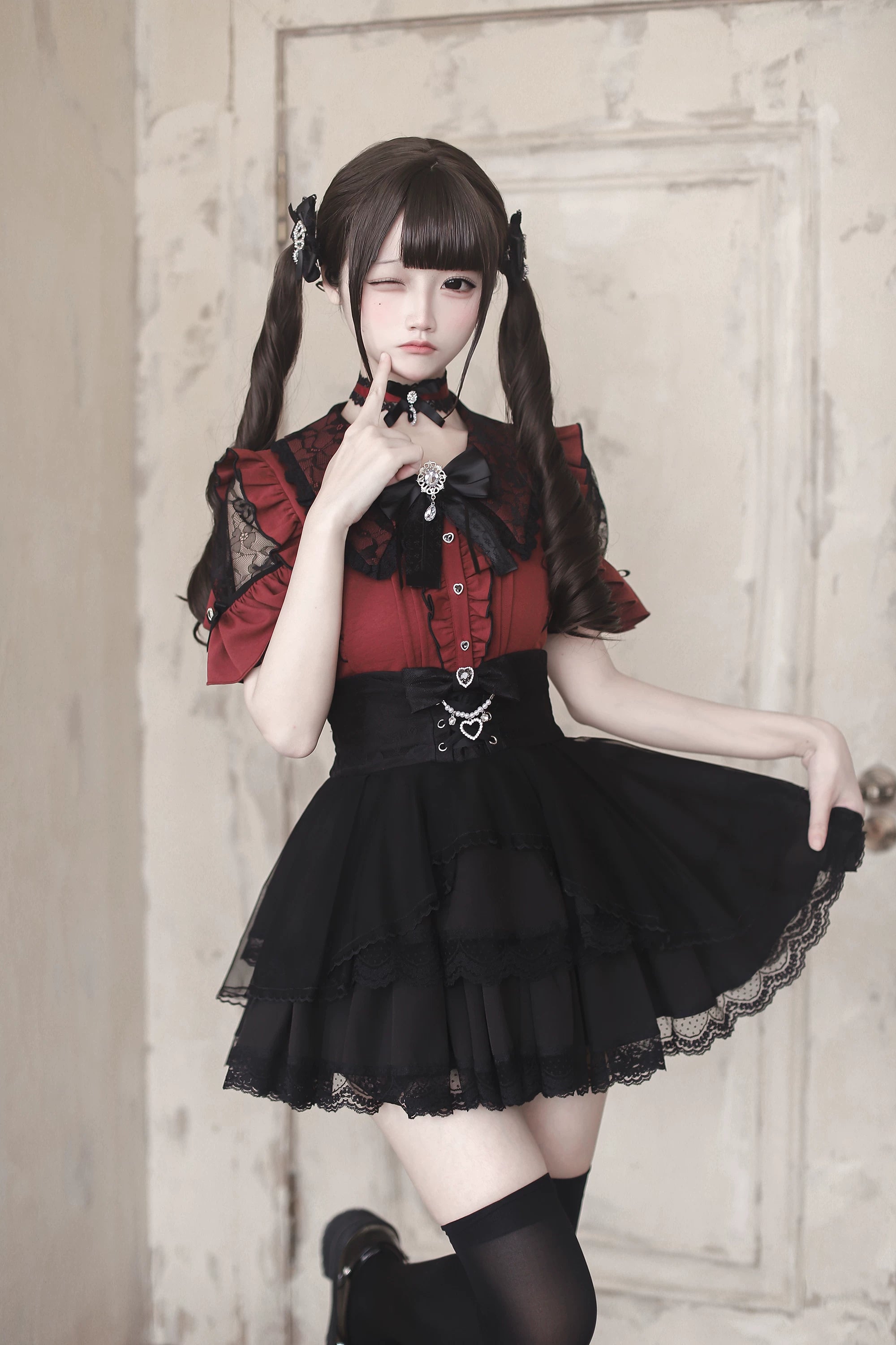 Red and black Jirai Kei ruffle sleeve blouse with lace trim and metal waist charm three-quarter view model