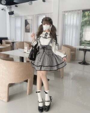 Jirai Kei lace blouse and plaid suspender skirt set full-body front view showing white ruffled shoulders black lace trim and heart-shaped pocket details with matching black platform shoes