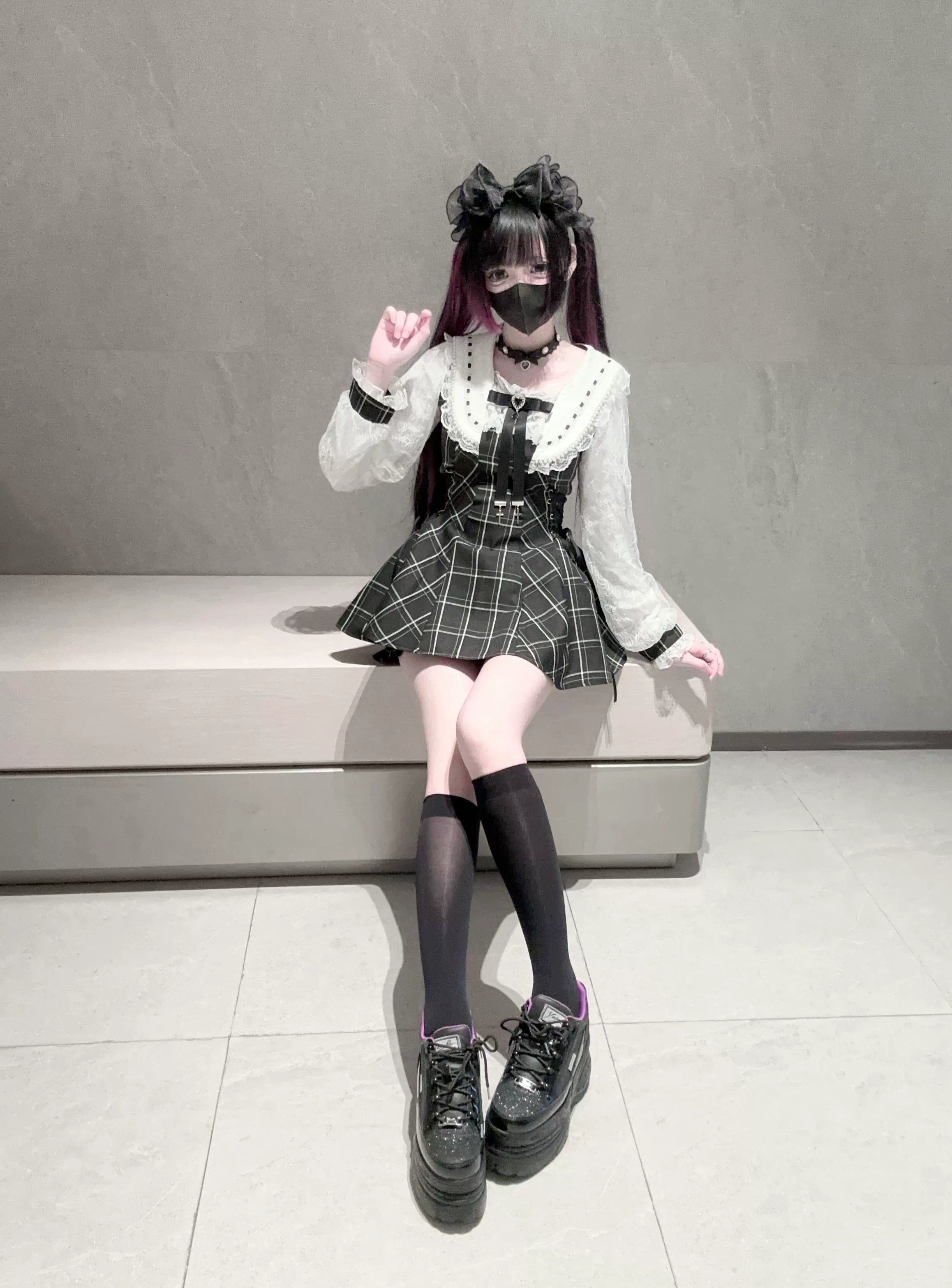 Flat lay styling of complete Jirai Kei two-piece set showing all components dress shorts collar bow arranged artistically