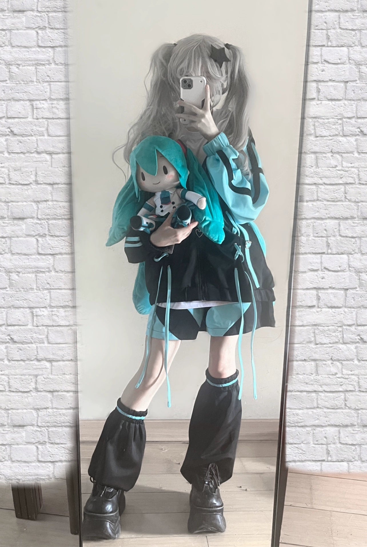 Jirai Kei lace-up hooded jacket back view showing color-blocking, cross-lacing pattern, and oversized hood structure on model wearing dark clothing
