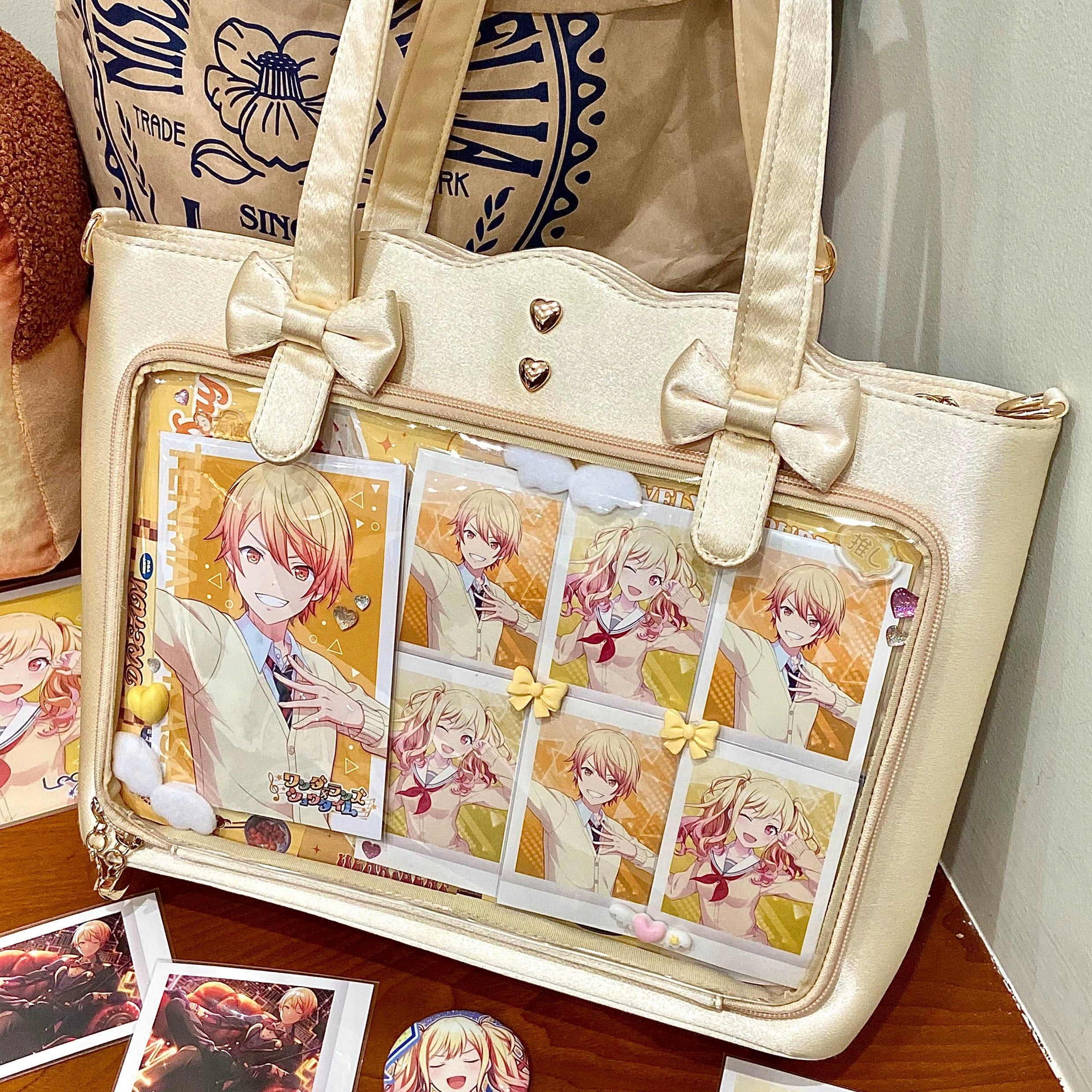 Yellow Jirai Kei ita bag bright color variant featuring heart-shaped metal studs, bow embellishments, clear character pin display window, wavy edge silhouette, and large capacity for anime badge collection