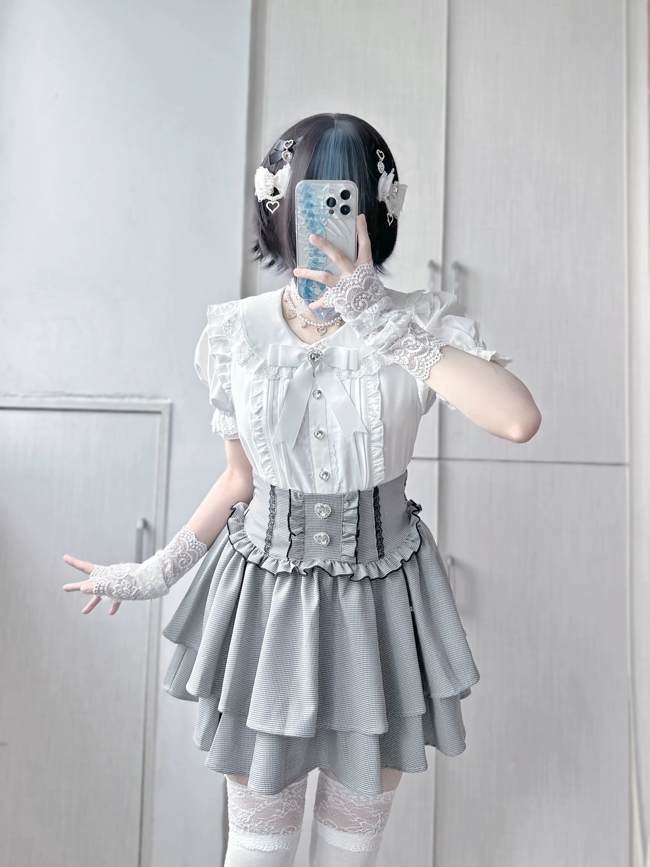 Houndstooth jirai kei tiered mini skirt product display, classic pattern with ruffled layers, heart rhinestone ornaments, premium quality
