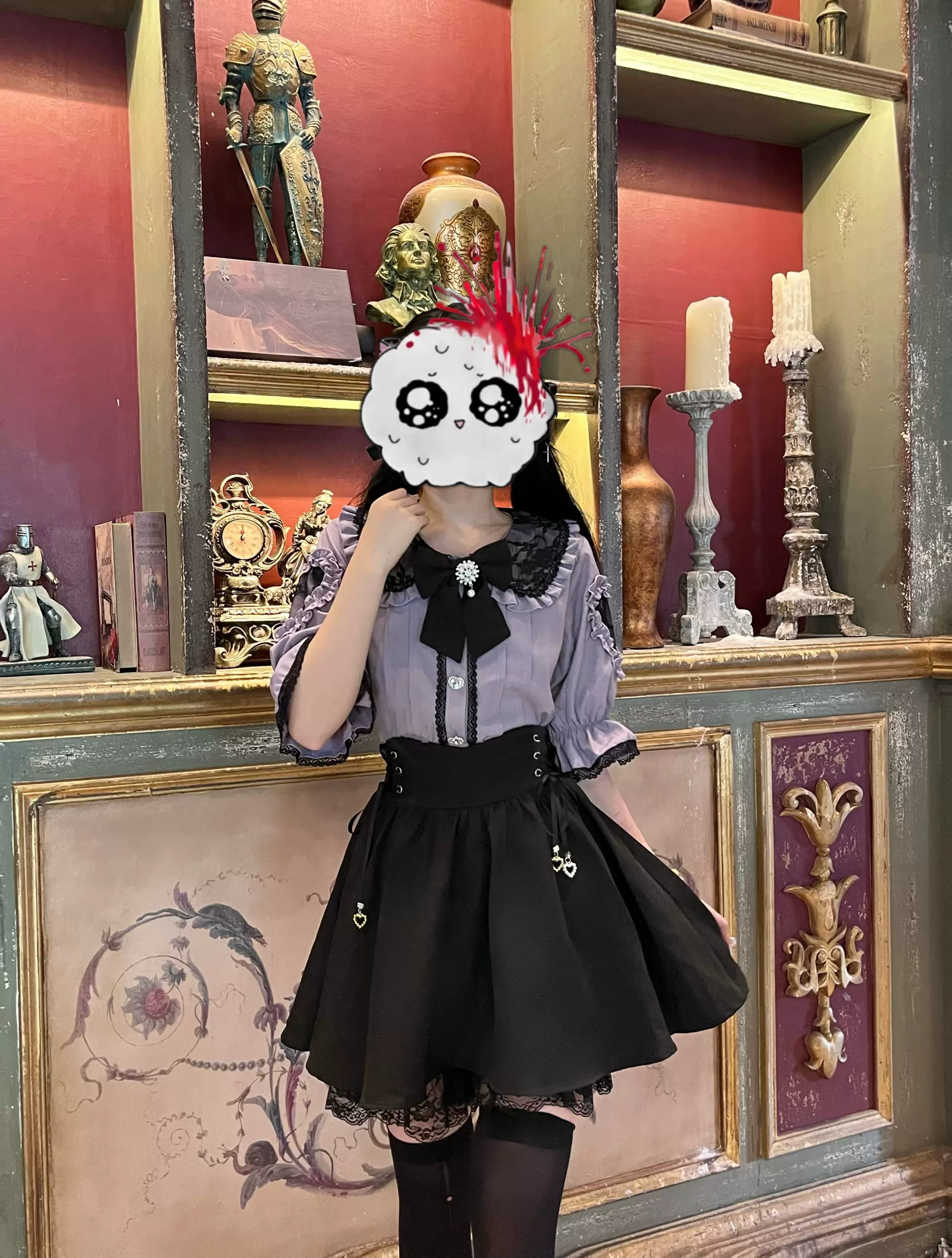 Light purple and black Jirai Kei outfit half-body portrait shot against vintage gothic decor background, featuring black high-waisted skirt with heart charms, puffed sleeves, and lace details - underground Japanese streetwear styling