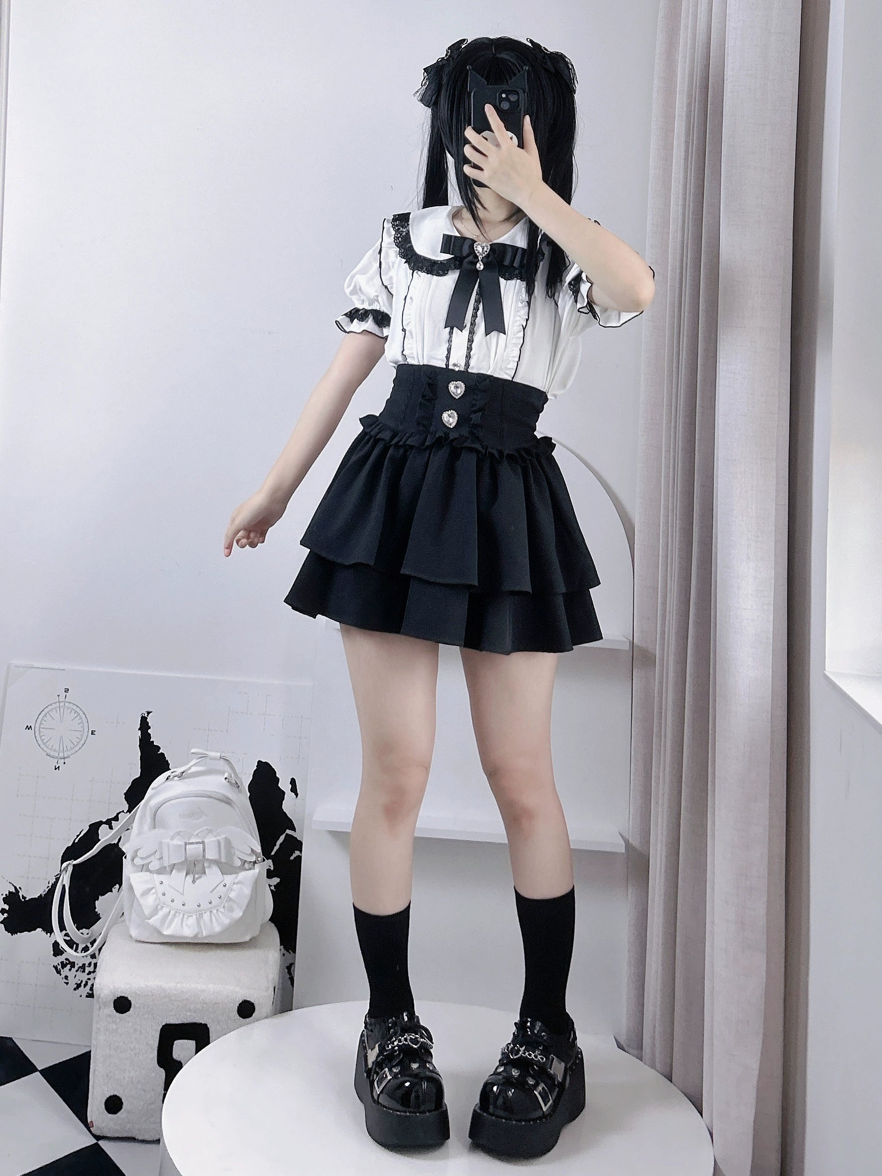 Jirai kei tiered mini skirt detail shot showing rhinestone heart ornaments and pleated waistband construction, closeup embellishment view