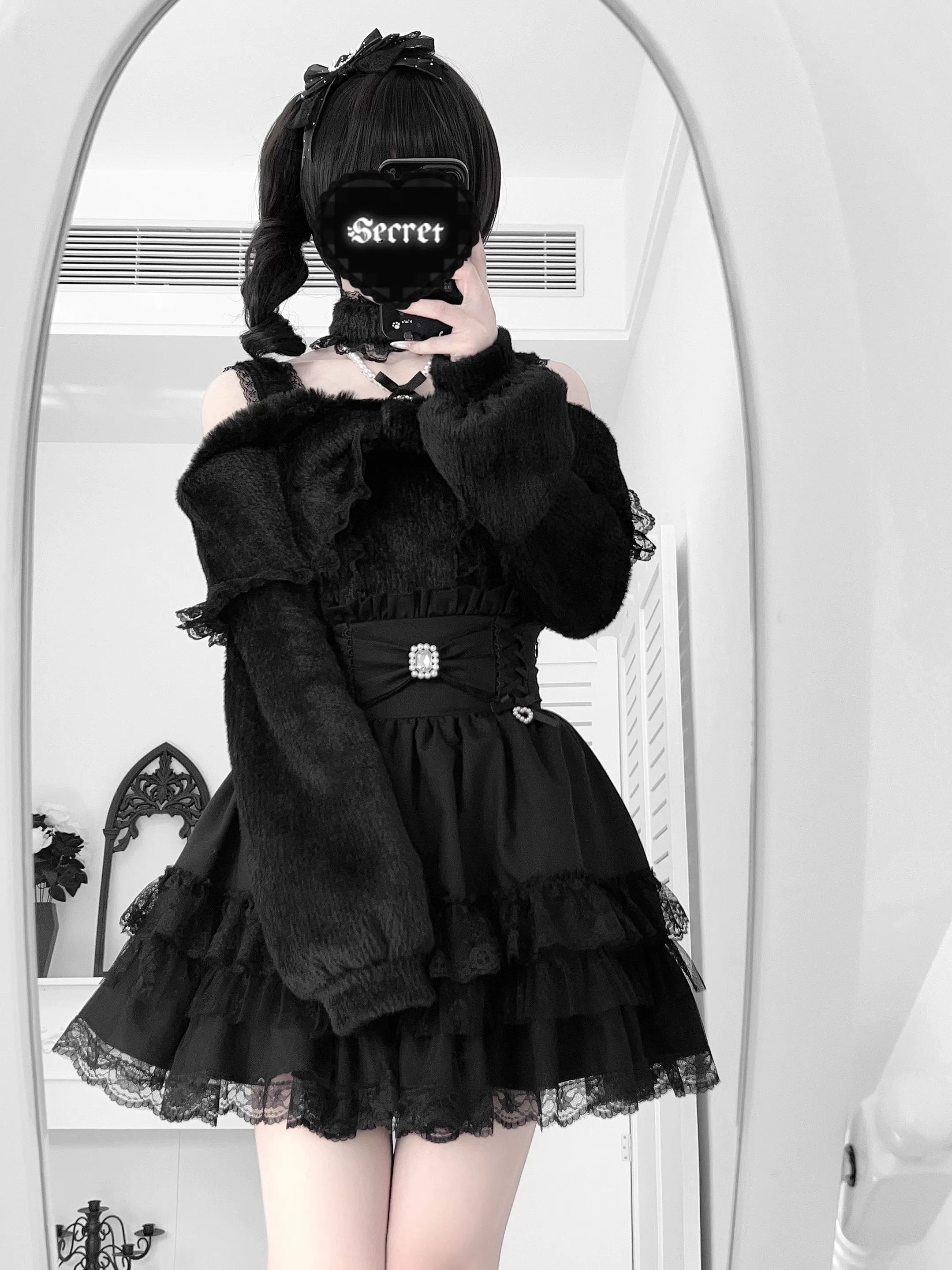 Black off-shoulder plush outfit set with long sleeves and ruffle tiered skirt worn in mirror selfie by goth girl with printed mask
