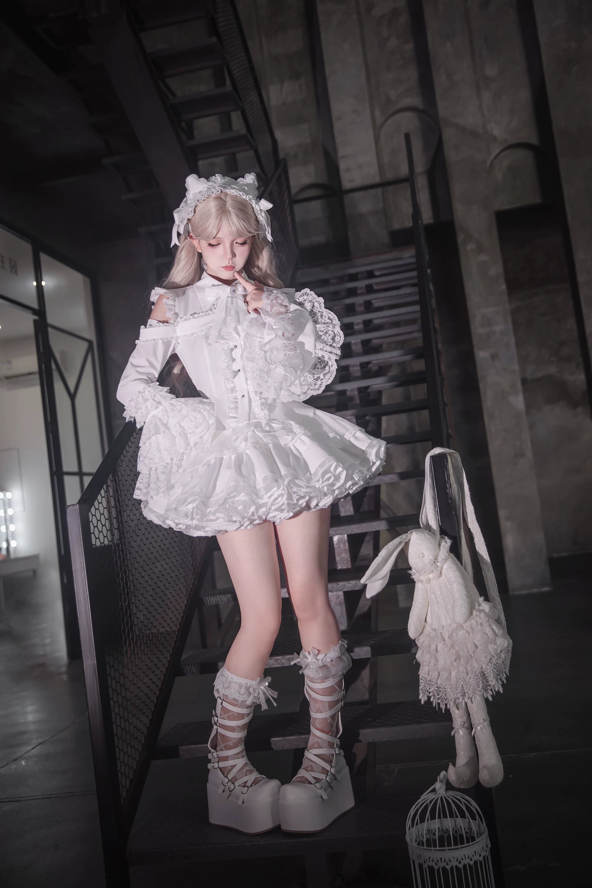 White lolita outfit ensemble side view featuring bell-shaped hime sleeves and layered ruffled mini skirt with full body modeling