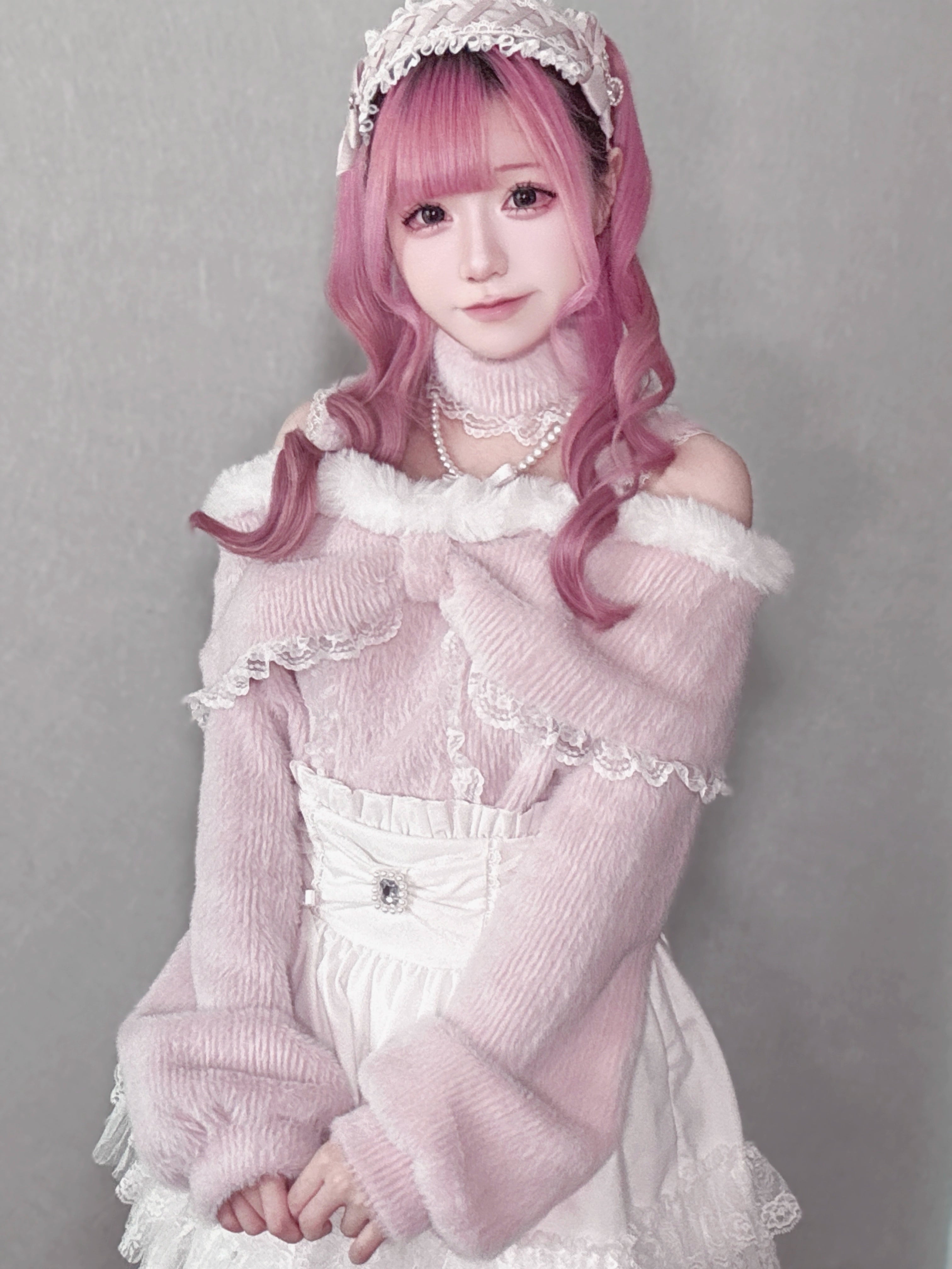 Pink off-shoulder plush top with pearl choker and ruffle collar worn by sweet lolita girl with pink hair and matching hairband, upper-body shot