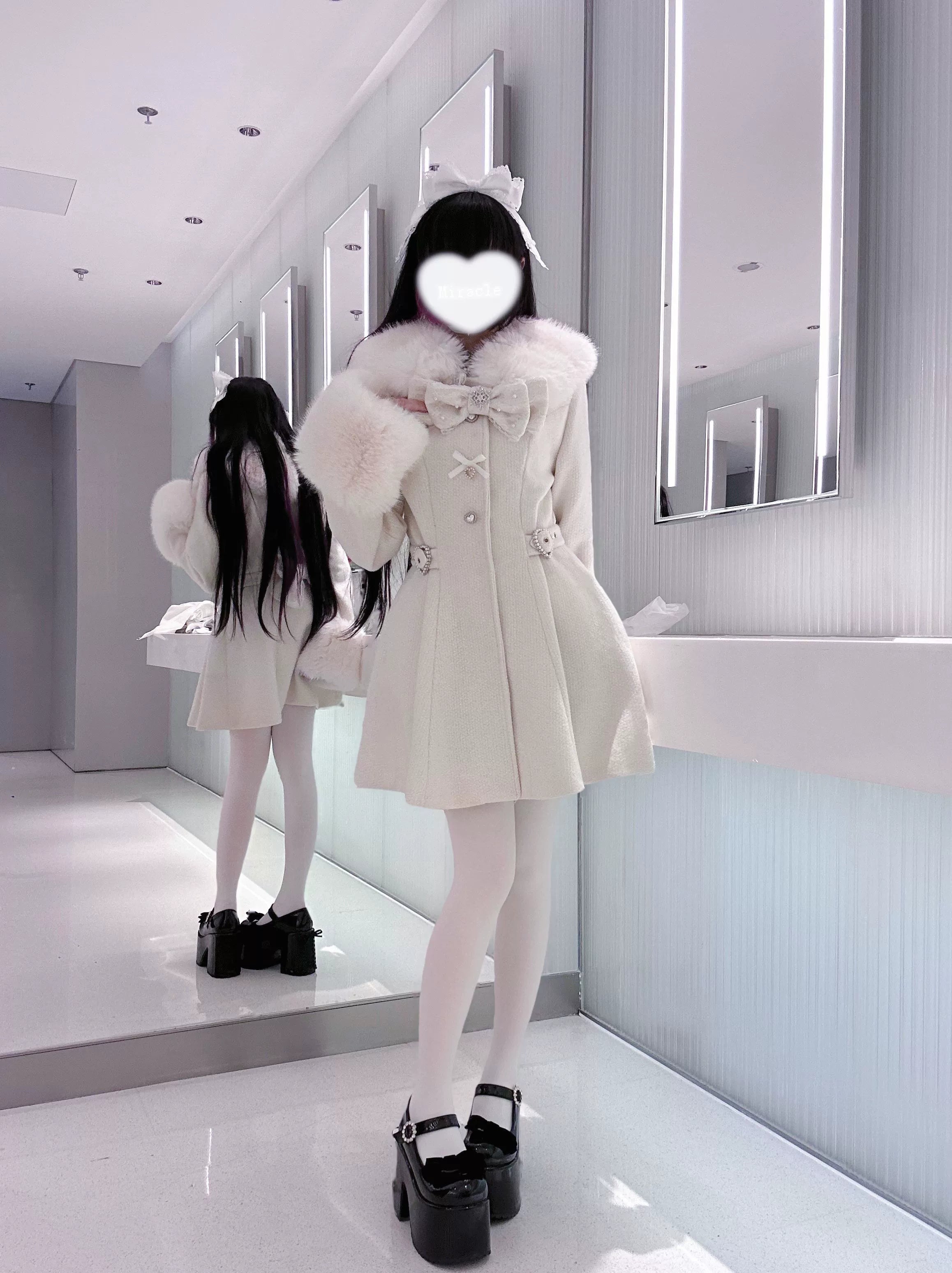 Black Ryousangata winter coat back view showing A-line silhouette detachable faux fur trim tailored waist construction on mannequin