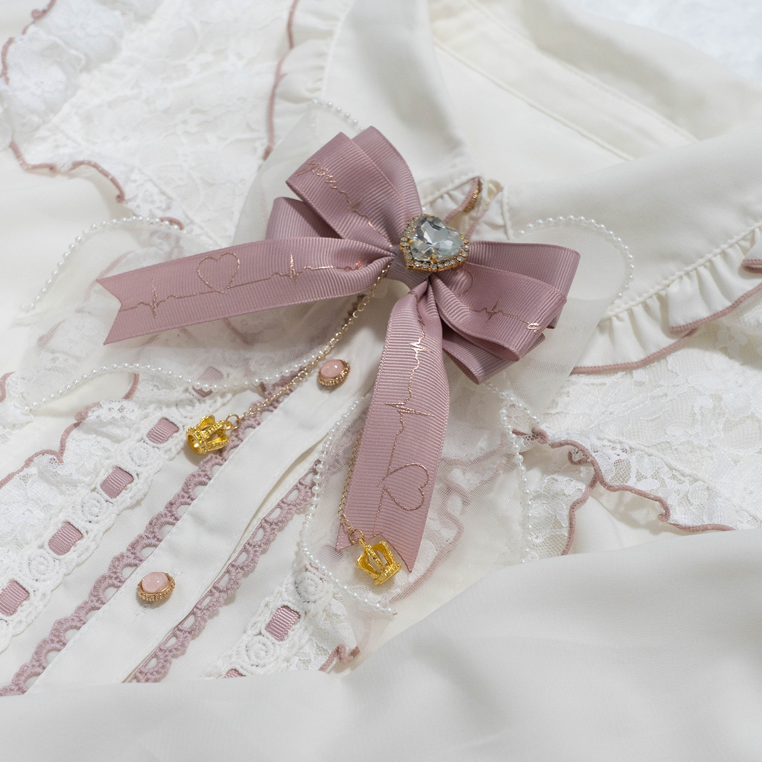 Pink satin Jirai Kei bow brooch styled on vintage white lace Lolita shirt collar with crystal pendant and rhinestone chain
