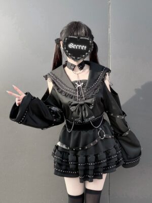 Gothic sailor top and skirt set side three-quarter angle showing bell sleeves chain decorations and bow front accents on female model with alternative styling