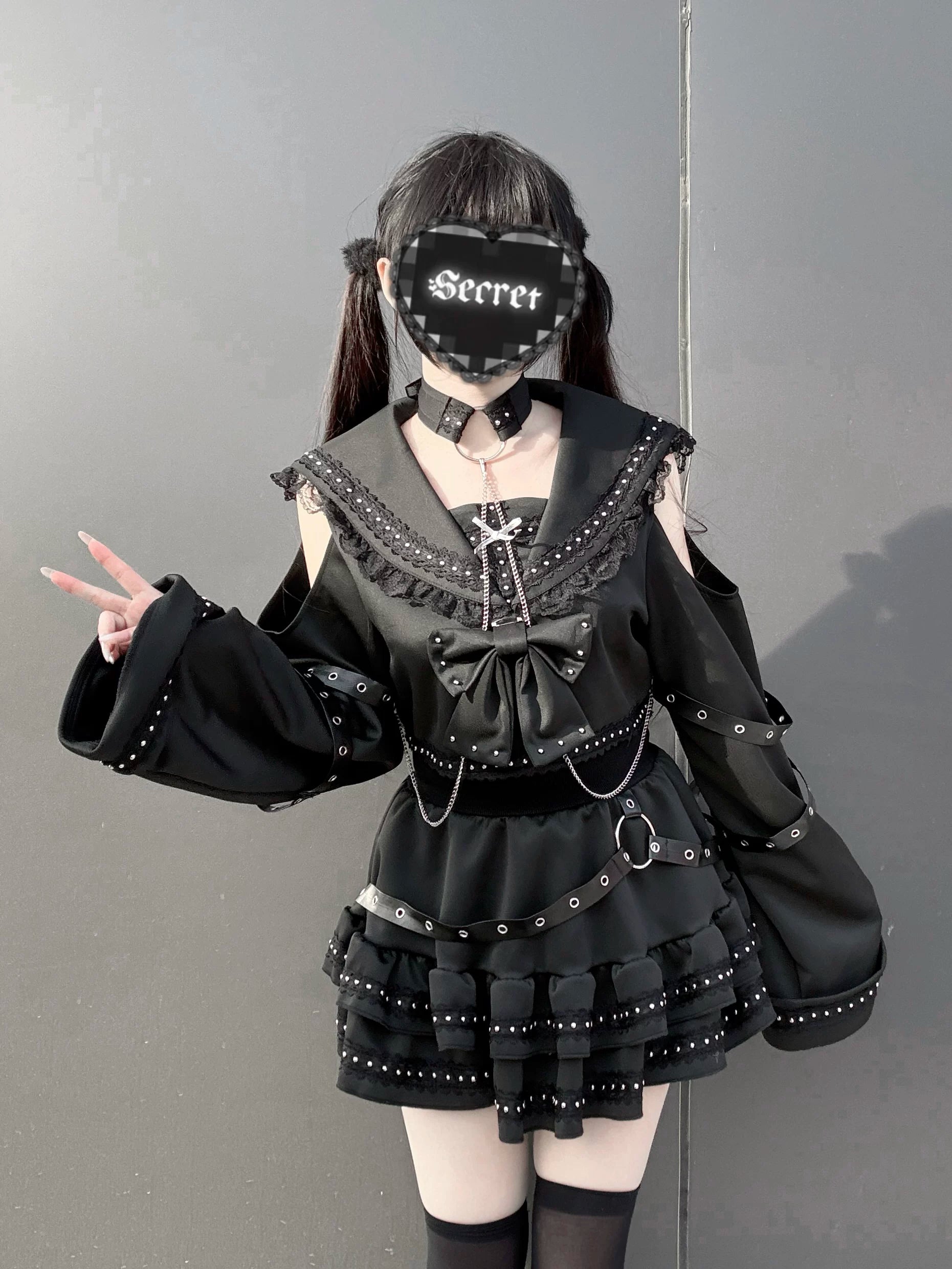 Gothic sailor top and skirt set side three-quarter angle showing bell sleeves chain decorations and bow front accents on female model with alternative styling