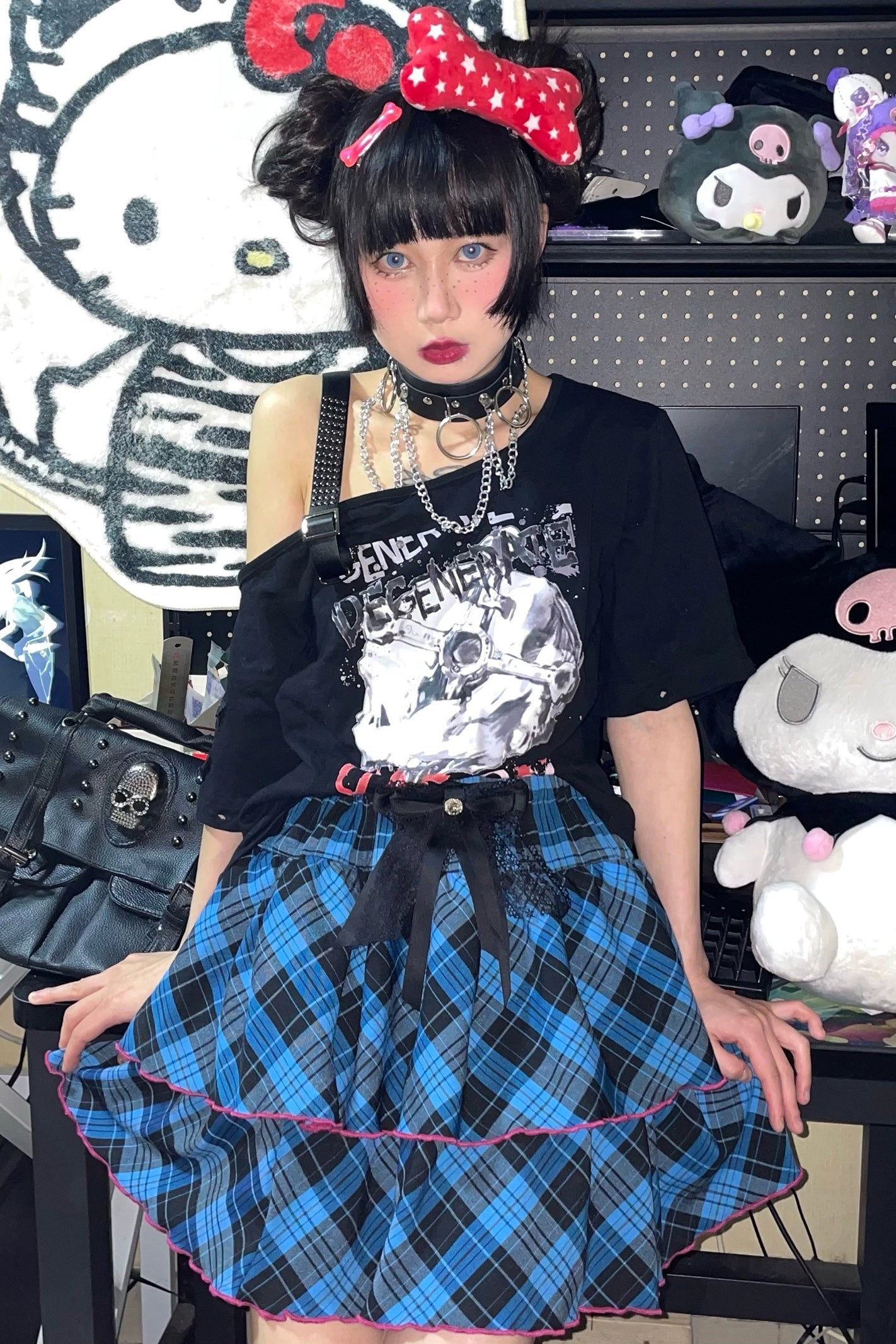Blue-black plaid Jirai Kei mini ruffle skirt with pink hem trim and statement lace bow, worn by Y2K goth model in gamer room aesthetic
