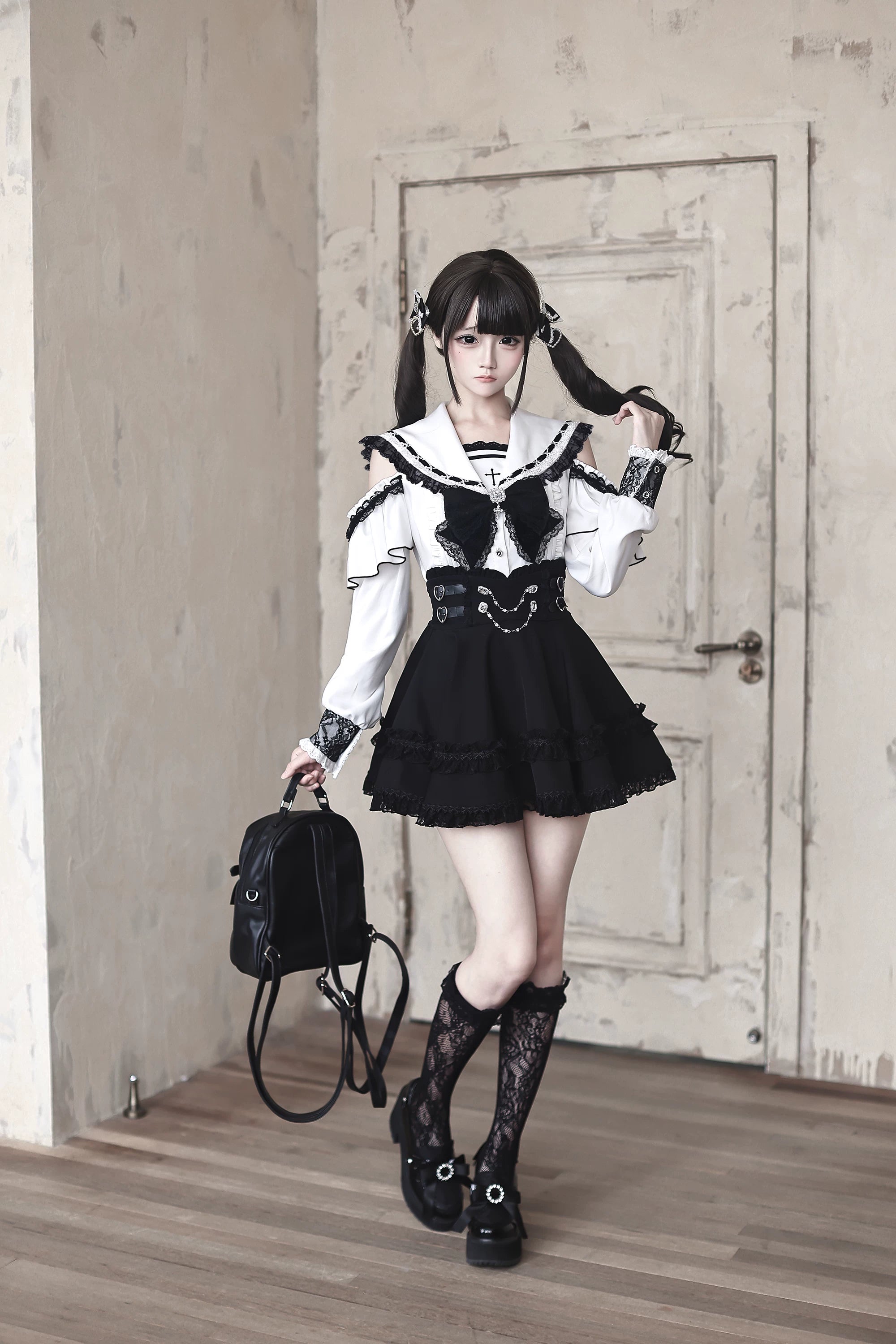 Sailor collar Jirai Kei blouse and high-waist skirt set worn by model with twin-tails in black and white lace ensemble, full front standing view