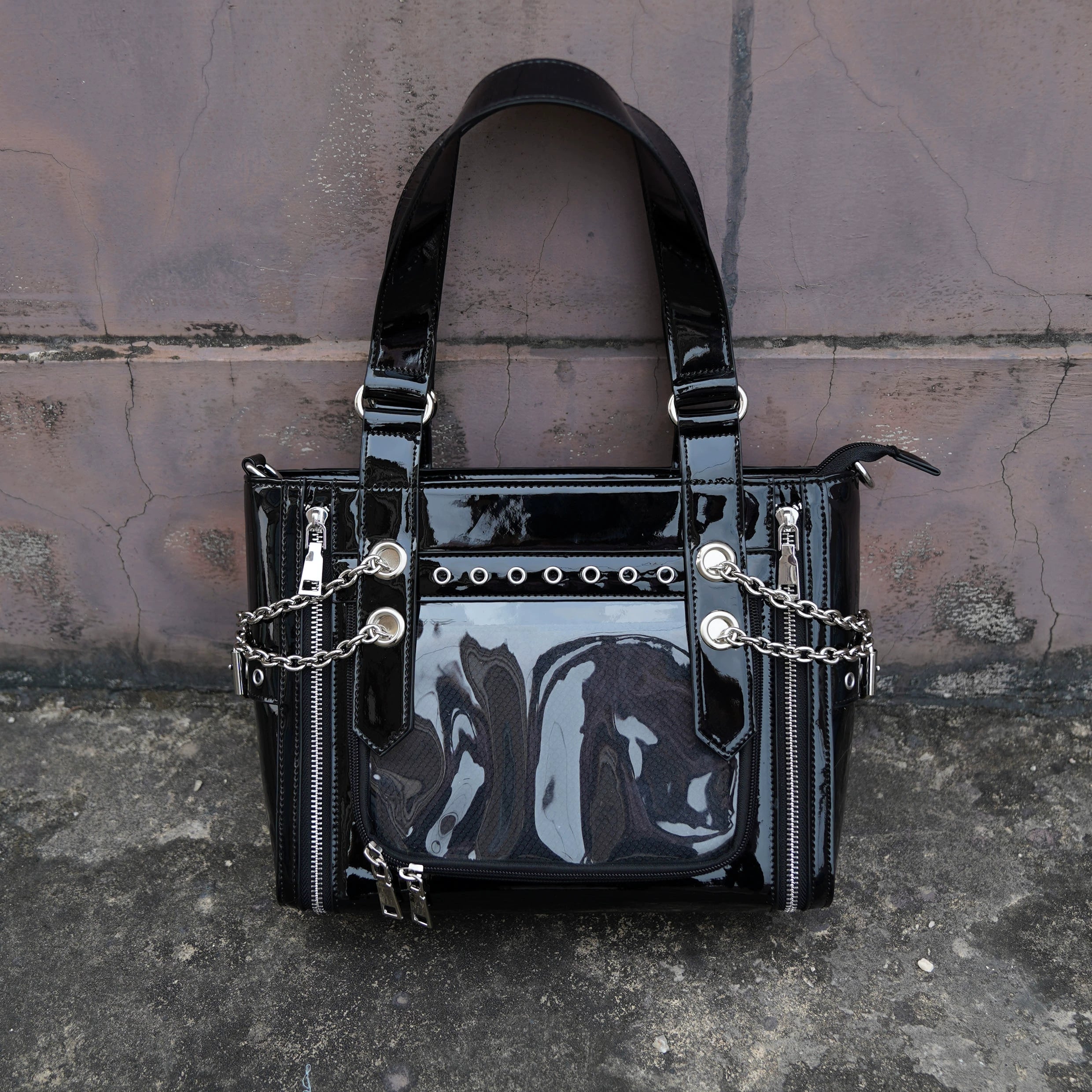 Black patent leather Jirai Kei ita tote bag front flat lay with metal chain accents clear transparent display window