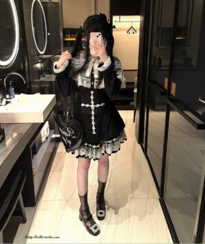 Full-body mirror selfie of Jirai Kei lace cape blouse with pearl buttons worn with black skirt and heart-shaped accessory in hotel bathroom setting
