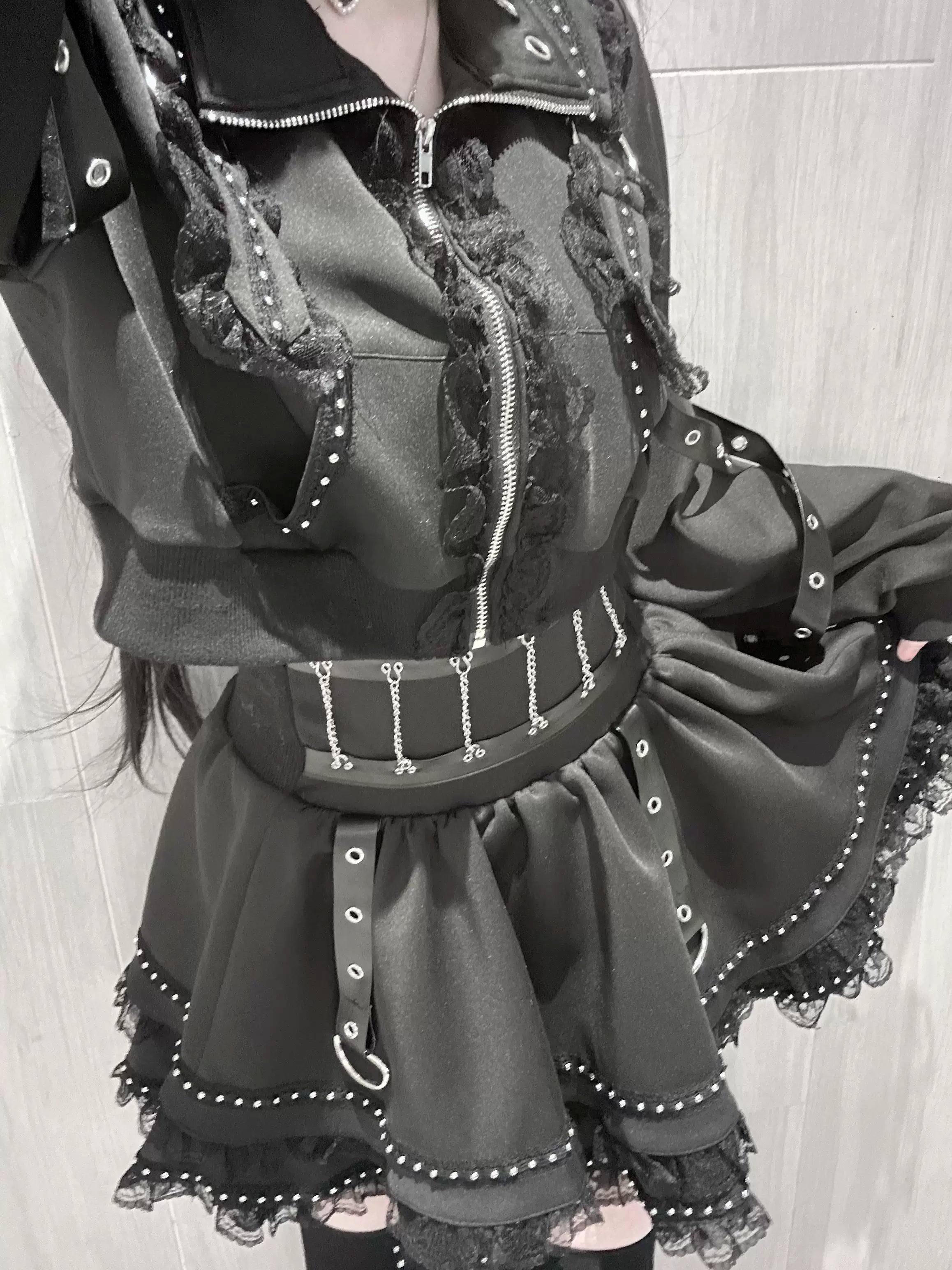 Black Jirai Kei punk jacket with cross zipper lace details and mini skirt ensemble detail shot studs hardware close-up