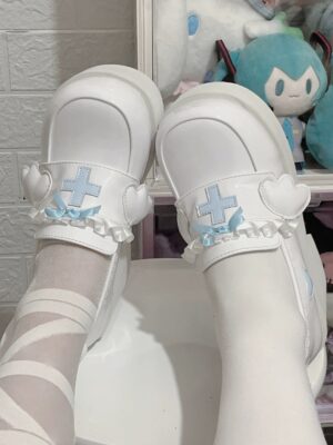 Jirai Kei high heel platform shoes glossy white finish blue cross decoration ruffle bow wing trim overhead shot with white leg wear bands