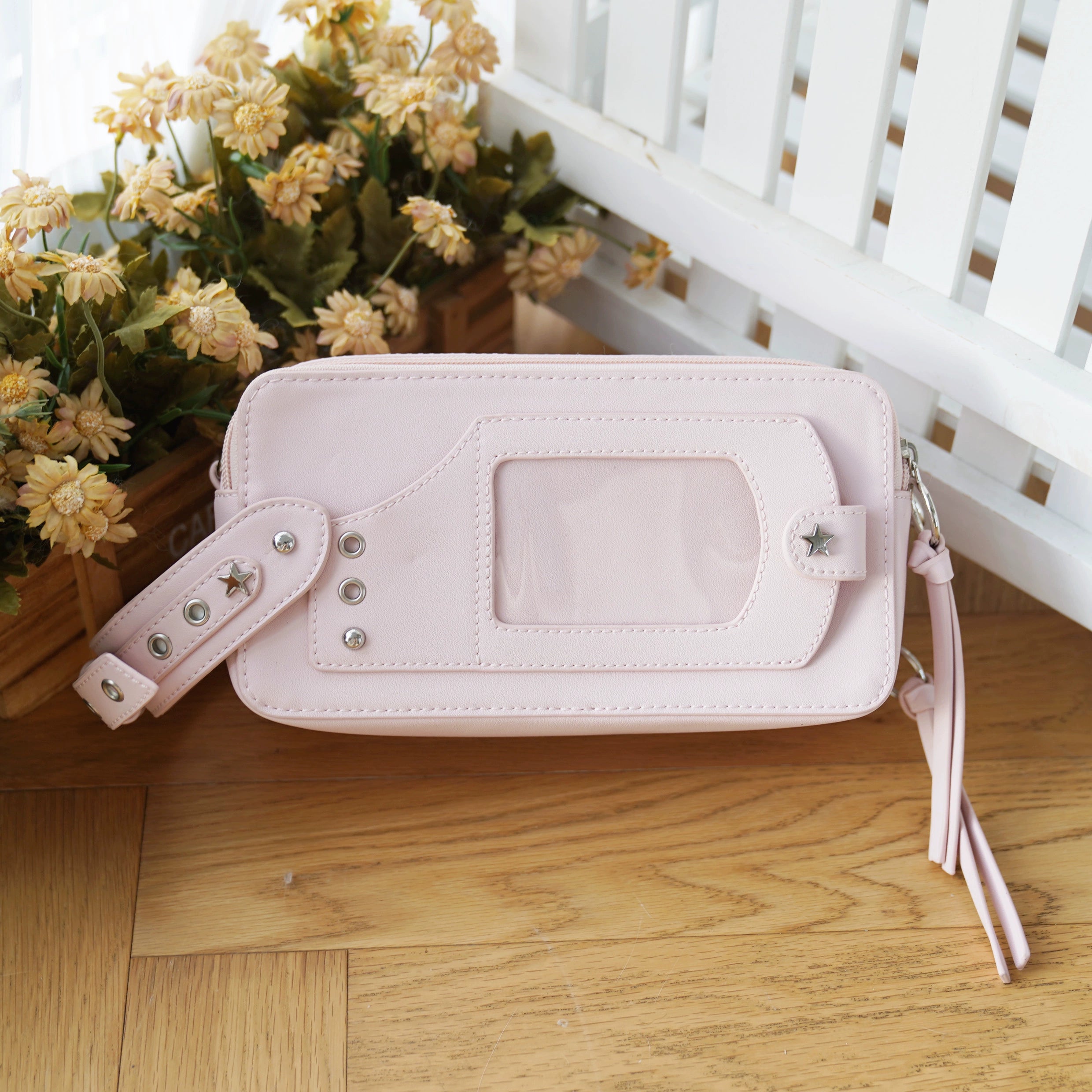 Jirai kei brick itabag pink color option lifestyle flat lay with anime trinkets and collectible accessories display