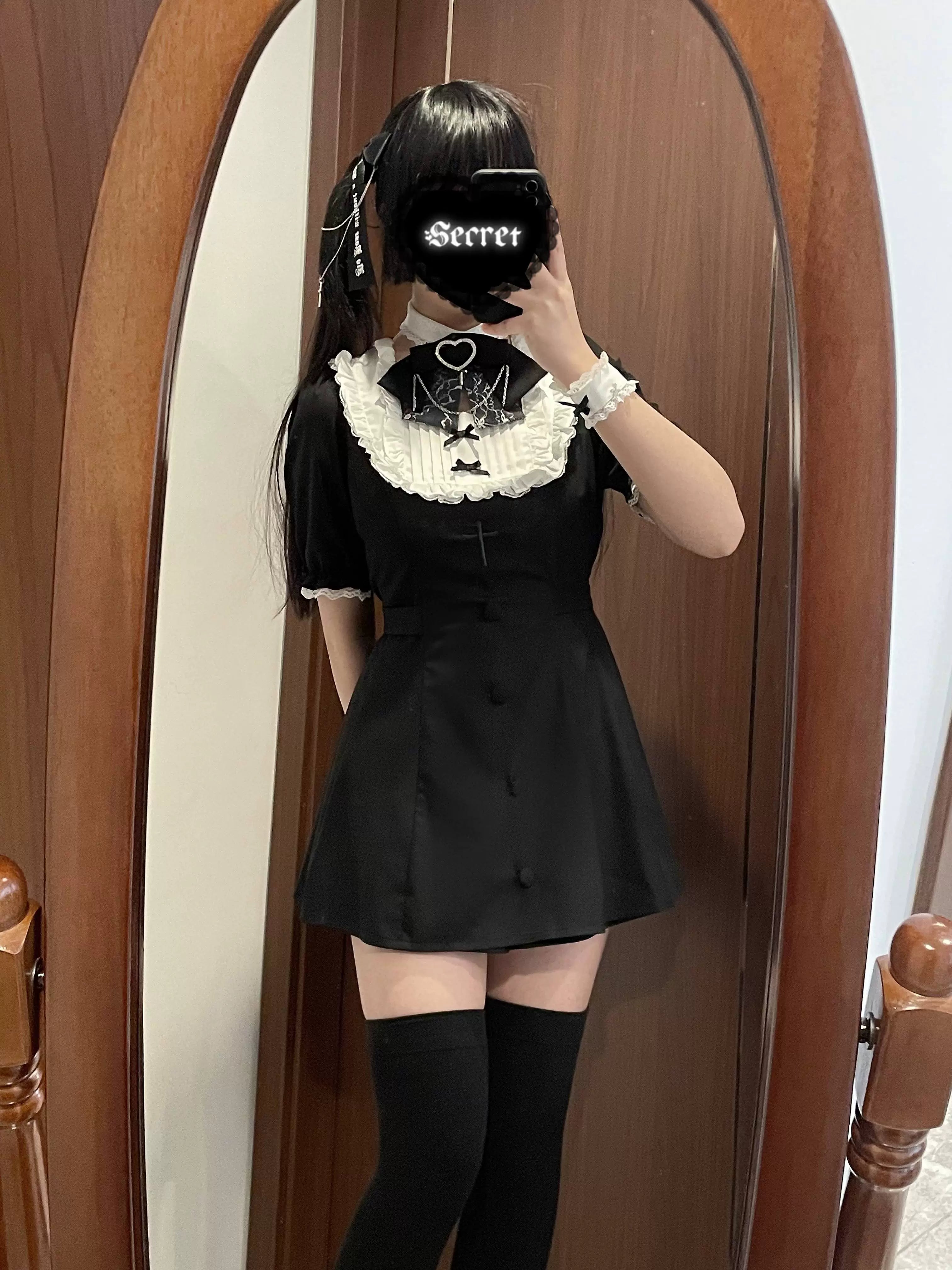 Black Jirai Kei mini dress shorts set with a-line silhouette front button details and thigh-high stockings side view