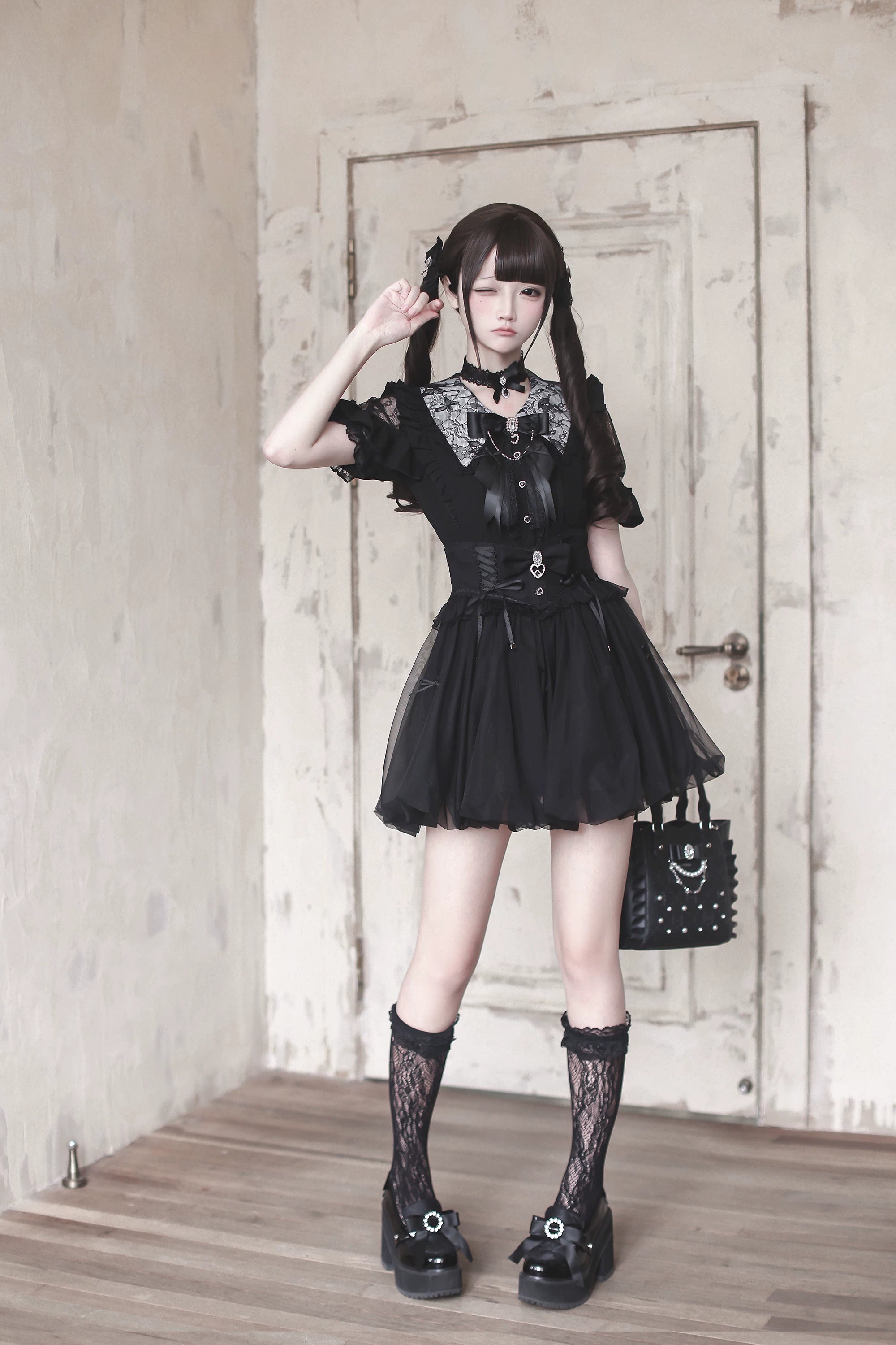 Black Jirai Kei bubble mini skirt with lace collar and bow necktie, model wearing fishnet lace socks and platform shoes, full body standing pose indoor