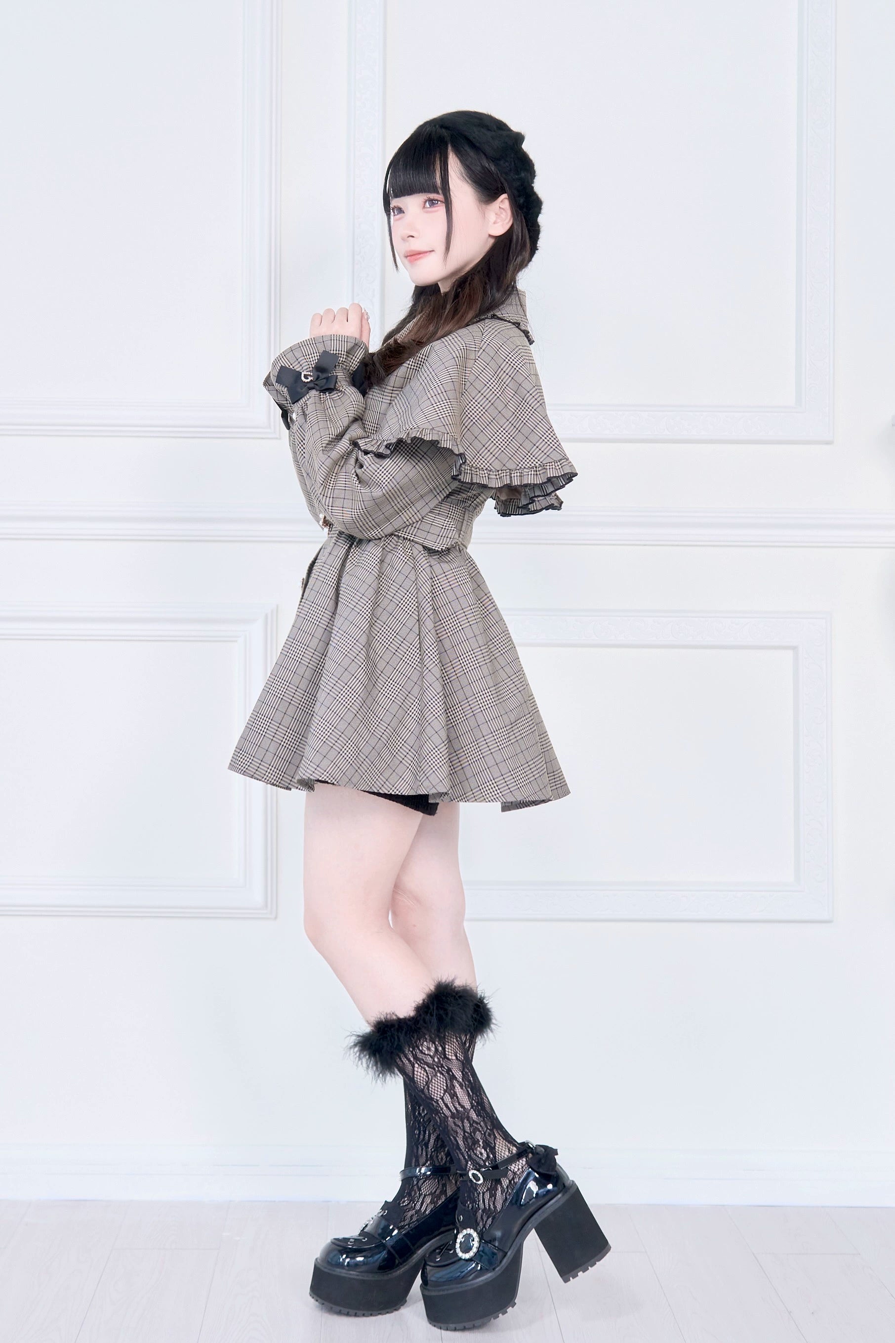 Plaid Jirai Kei cape trench coat side three-quarter view showing puff sleeves belted waist and lace sock details