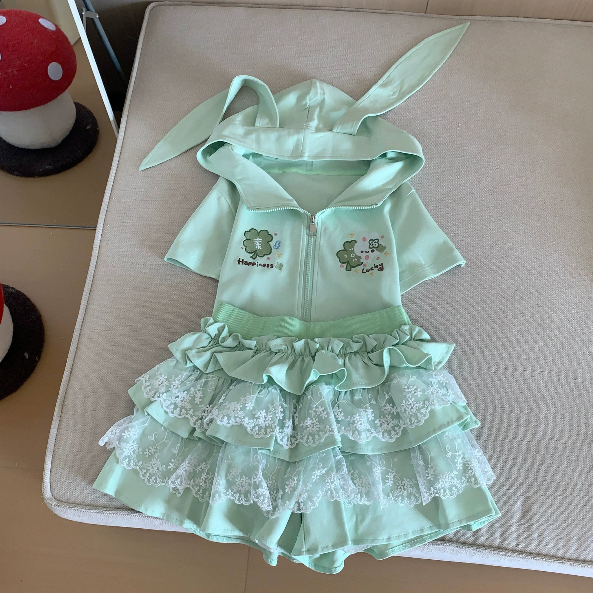 Styling inspiration for mint green Jirai Kei bunny ear hoodie and lace ruffle skirt two-piece outfit, showing coordination with accessories and footwear for complete look