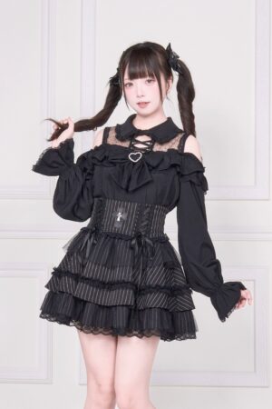 Black cold-shoulder Jirai Kei blouse with lace-up detailing and ruffle skirt three-quarter front view on model