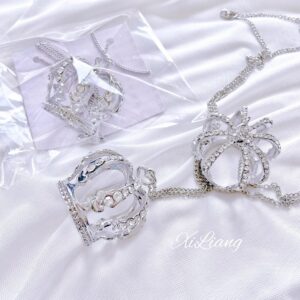 Crown rhinestone necklace and matching ring set in plastic packaging on white satin, silver hollow crown designs with rhinestone embellishments attached to metal chains